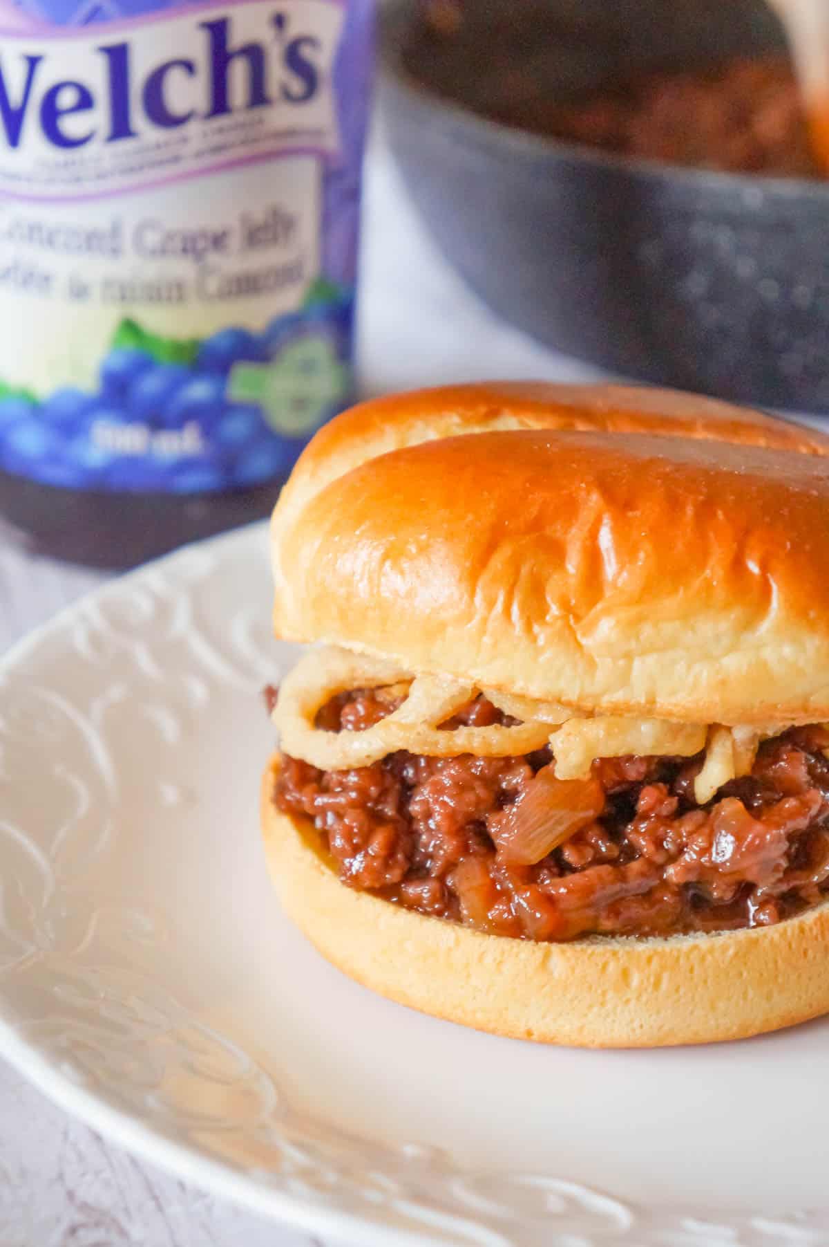 Grape Jelly BBQ Sloppy Joes are a fun twist on the classic sandwich. These tasty sloppy joes are made with ground beef tossed in a mixture of grape jelly and BBQ sauce and topped with French's crispy fried onions.