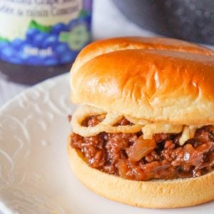 Grape Jelly BBQ Sloppy Joes are a fun twist on the classic sandwich. These tasty sloppy joes are made with ground beef tossed in a mixture of grape jelly and BBQ sauce and topped with French's crispy fried onions.