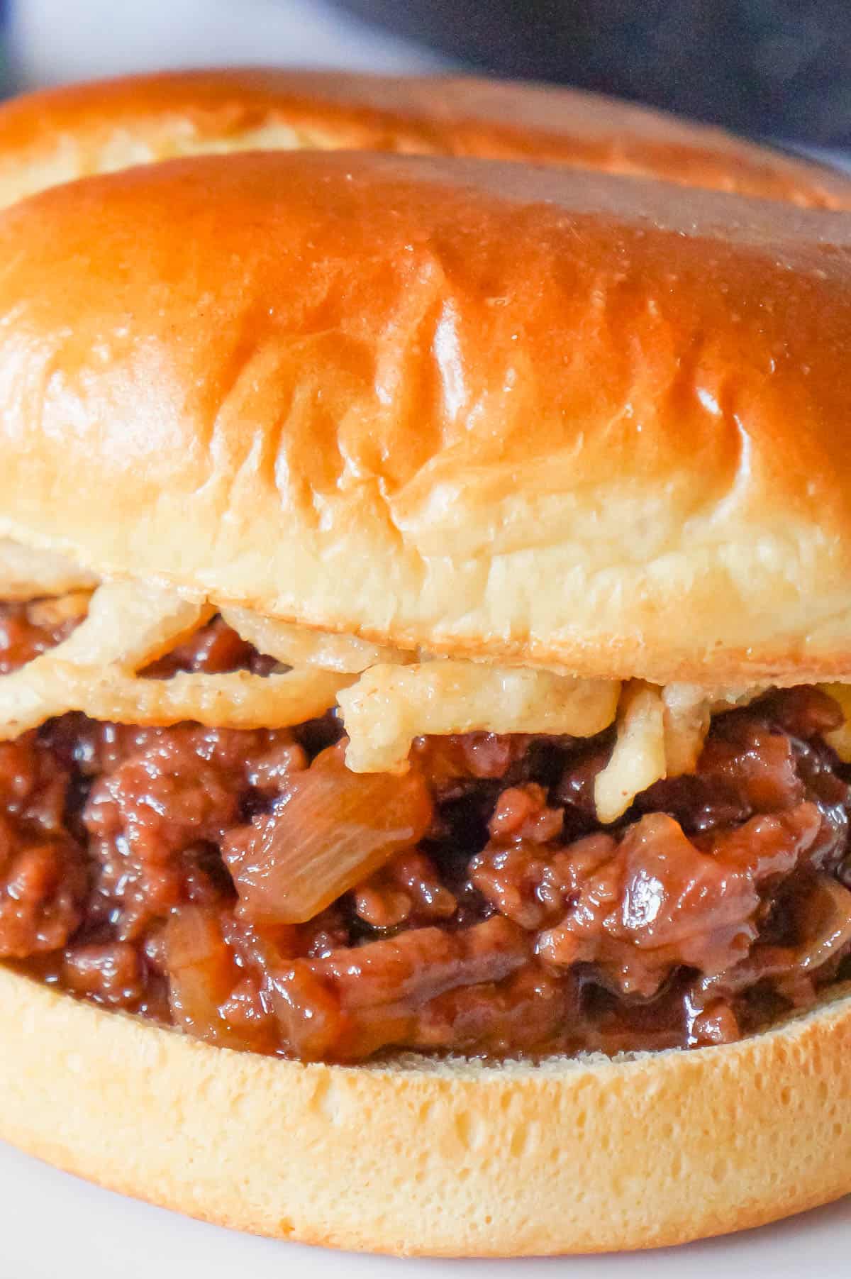 Grape Jelly BBQ Sloppy Joes are a fun twist on the classic sandwich. These tasty sloppy joes are made with ground beef tossed in a mixture of grape jelly and BBQ sauce and topped with French's crispy fried onions.
