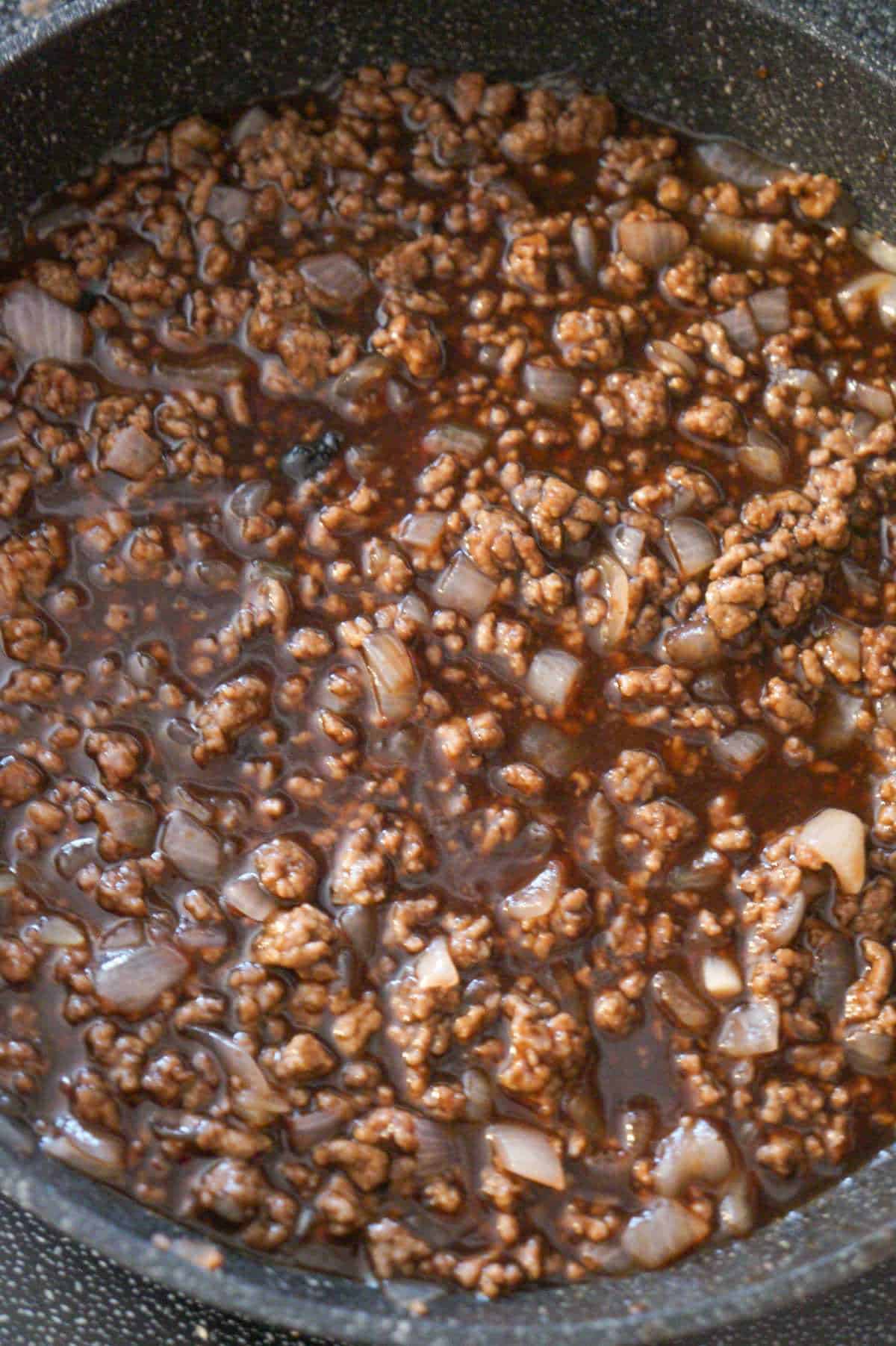 grape jelly bbq sloppy joe mixture simmering in a pan