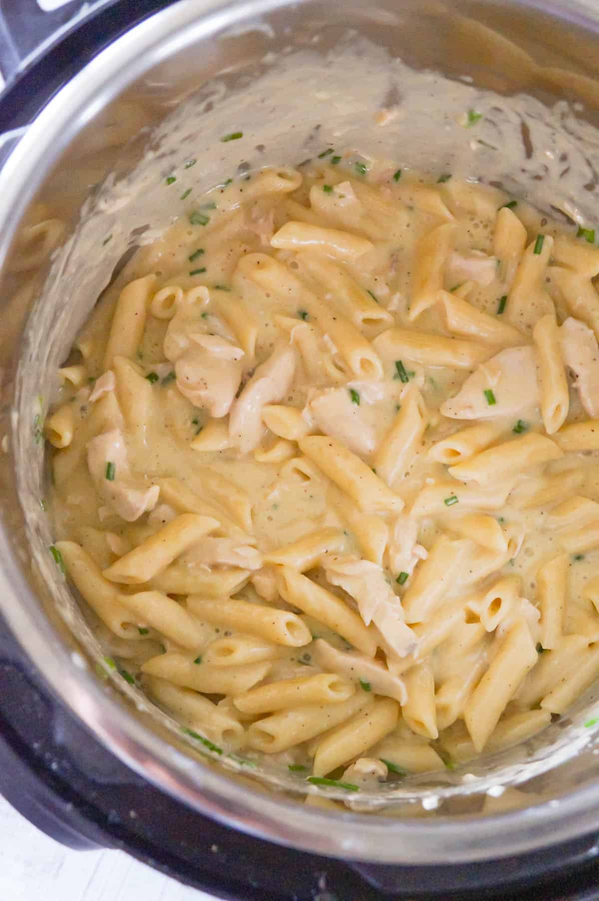 Instant Pot Garlic Parmesan Chicken and Pasta is a delicious pressure cooker pasta recipe loaded with chunks of chicken breast in a creamy Parmesan cheese sauce.