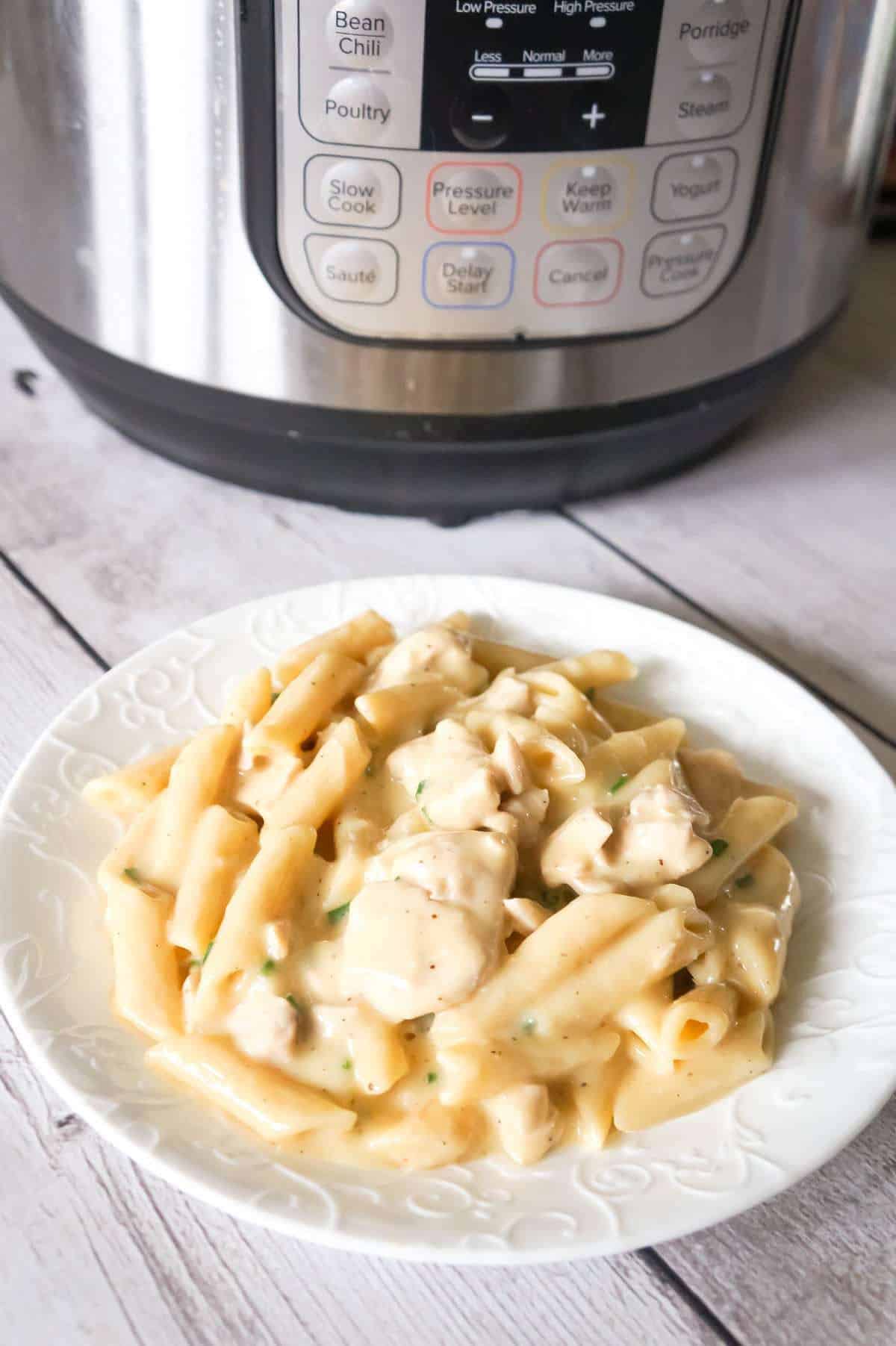 Instant Pot Garlic Parmesan Chicken and Pasta is a delicious pressure cooker pasta recipe loaded with chunks of chicken breast in a creamy Parmesan cheese sauce.