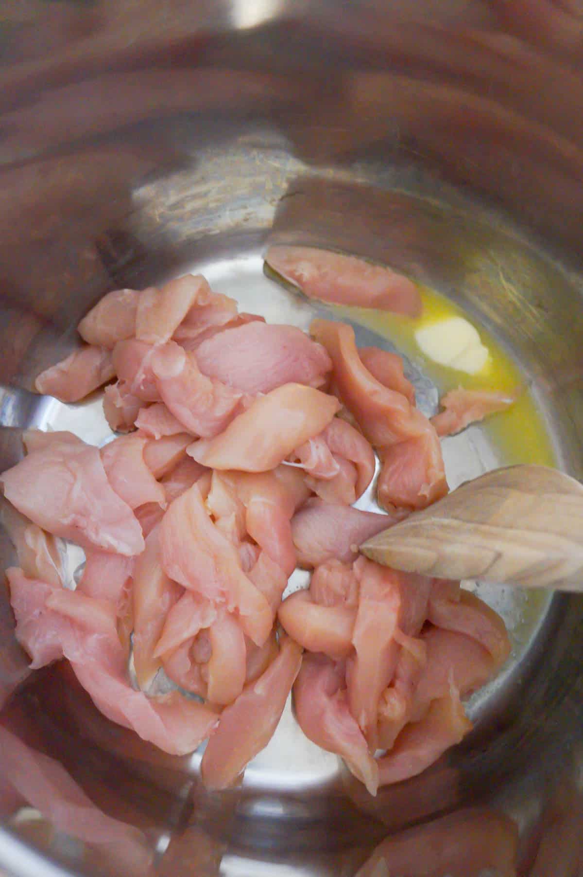 raw chicken breast strips in an Instant Pot