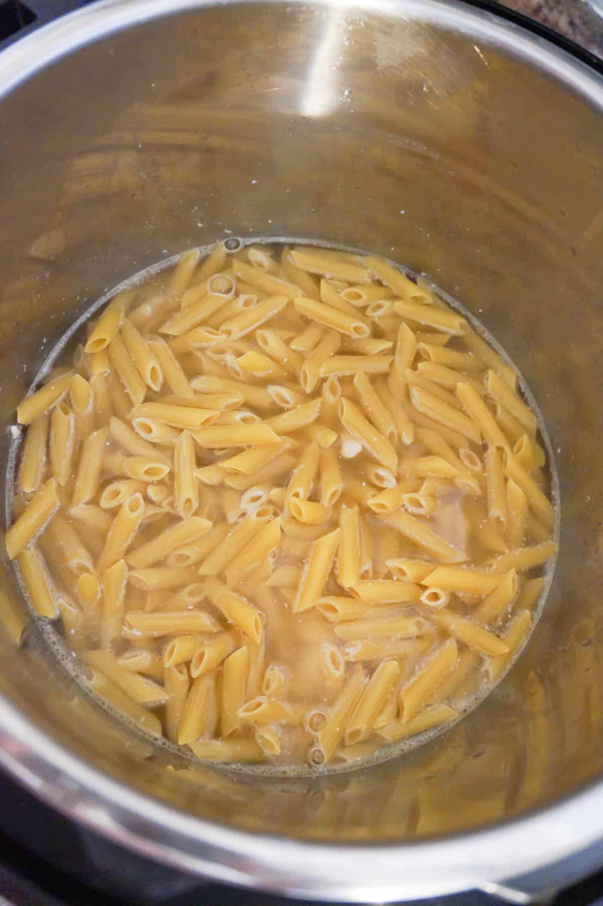 penne pasta in chicken broth in an Instant Pot