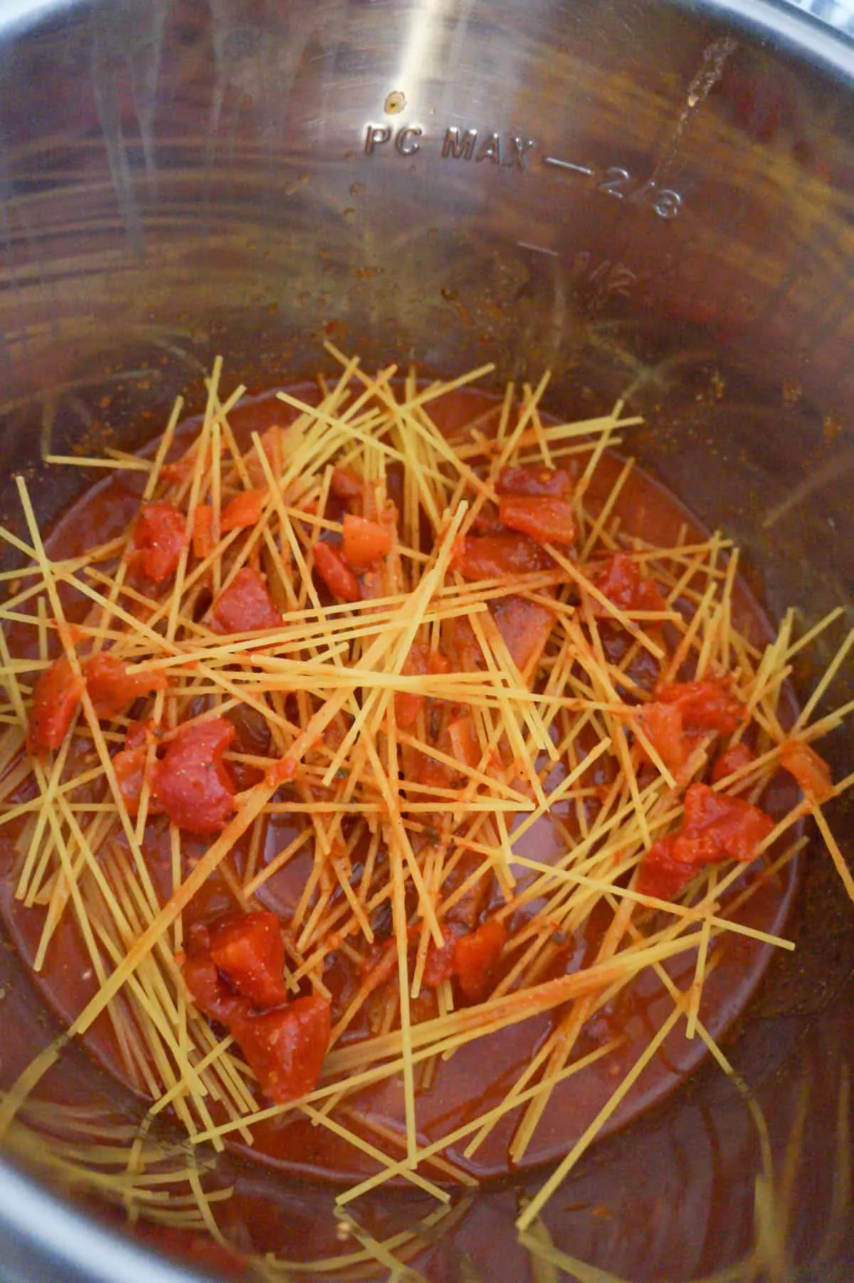 uncooked spaghetti and marinara sauce in an Instant Pot