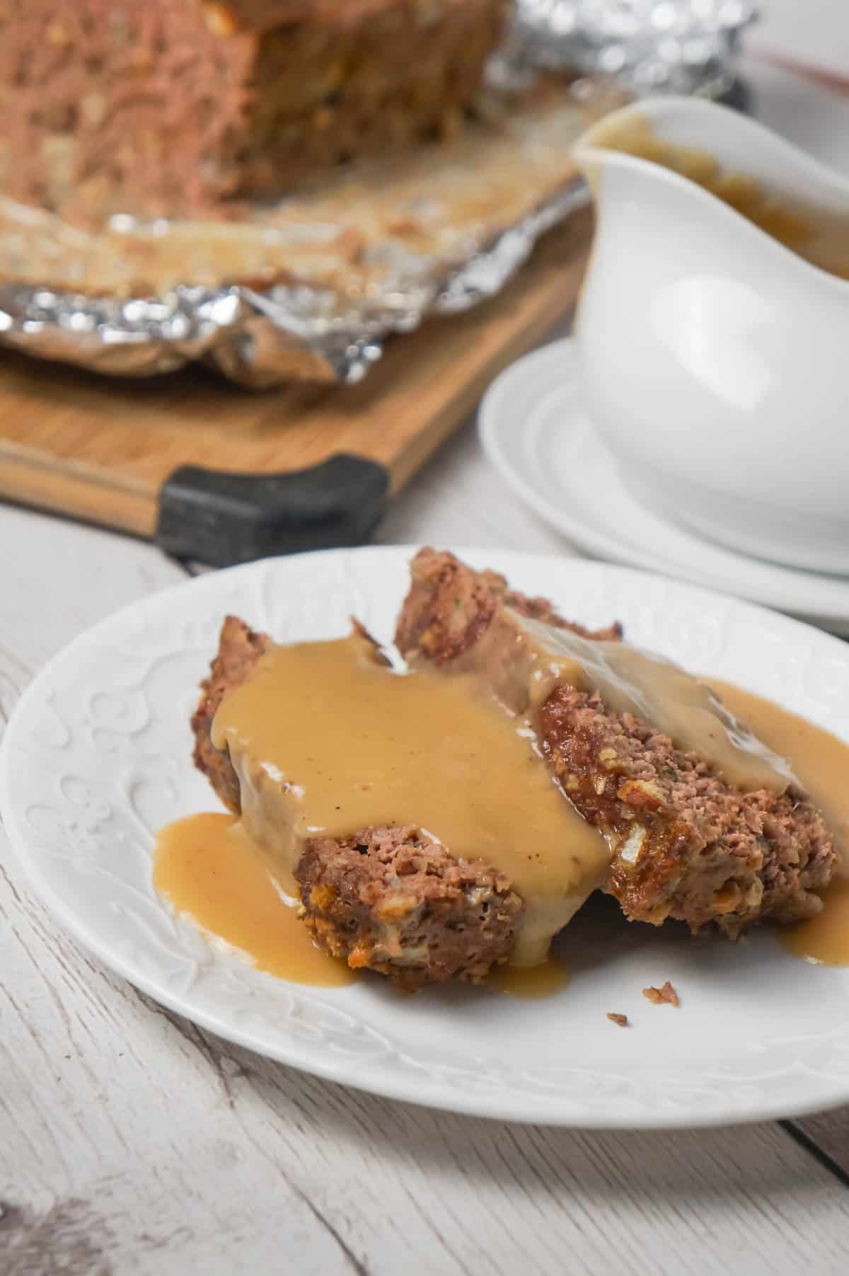 Meatloaf with Gravy is an easy 2 pound ground beef meatloaf recipe made with Stove Top stuffing mix and served with homemade gravy.