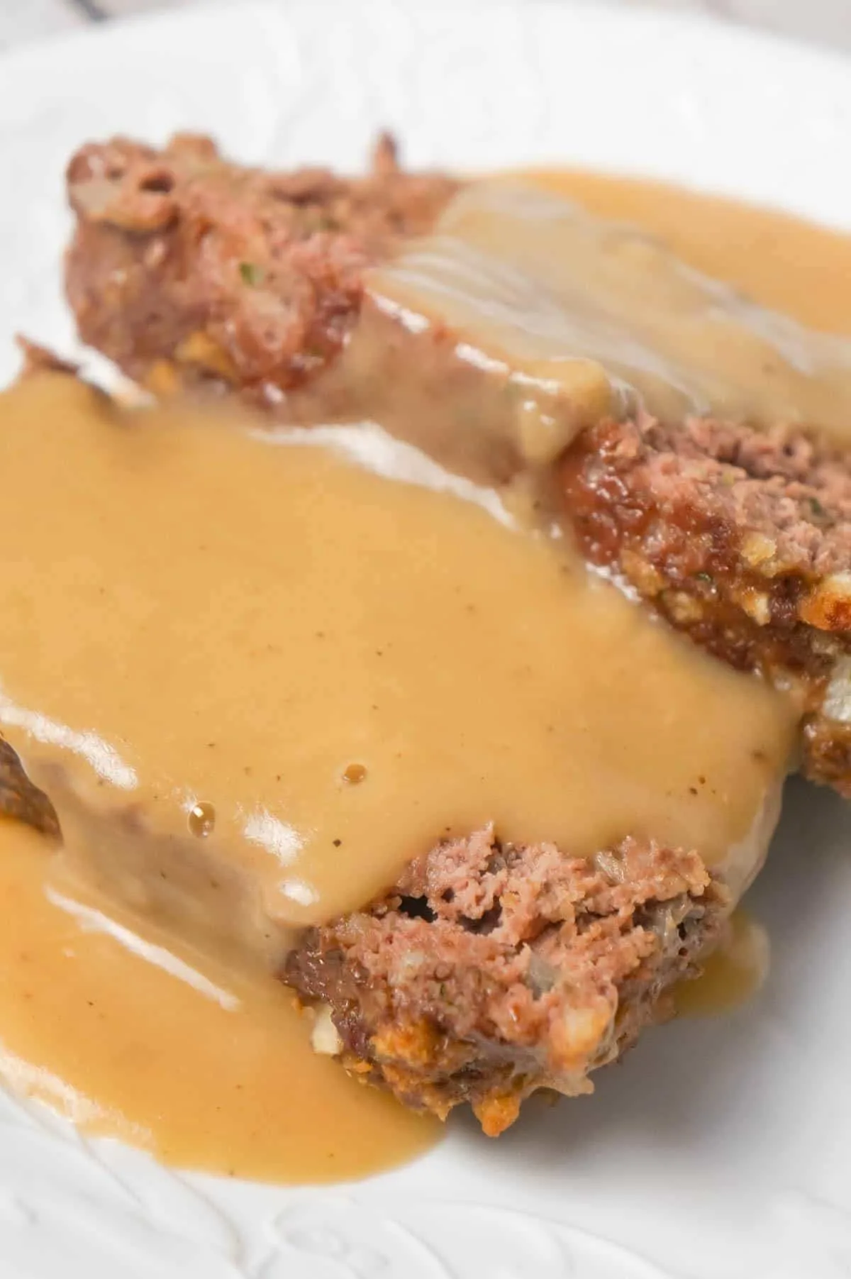 Meatloaf with Gravy is an easy 2 pound ground beef meatloaf recipe made with Stove Top stuffing mix and served with homemade gravy.