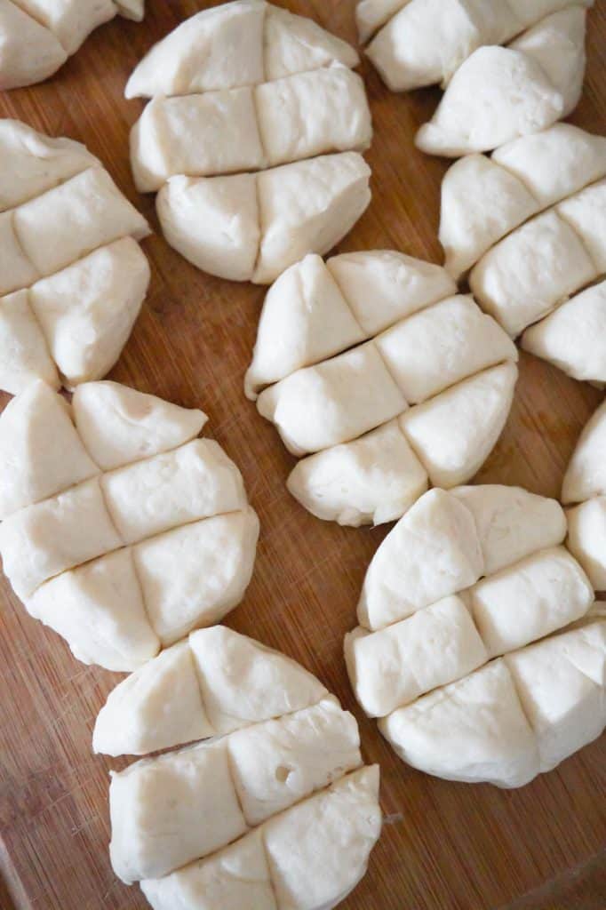 pillsbury refrigerated biscuit dough cut into pieces on a cutting board