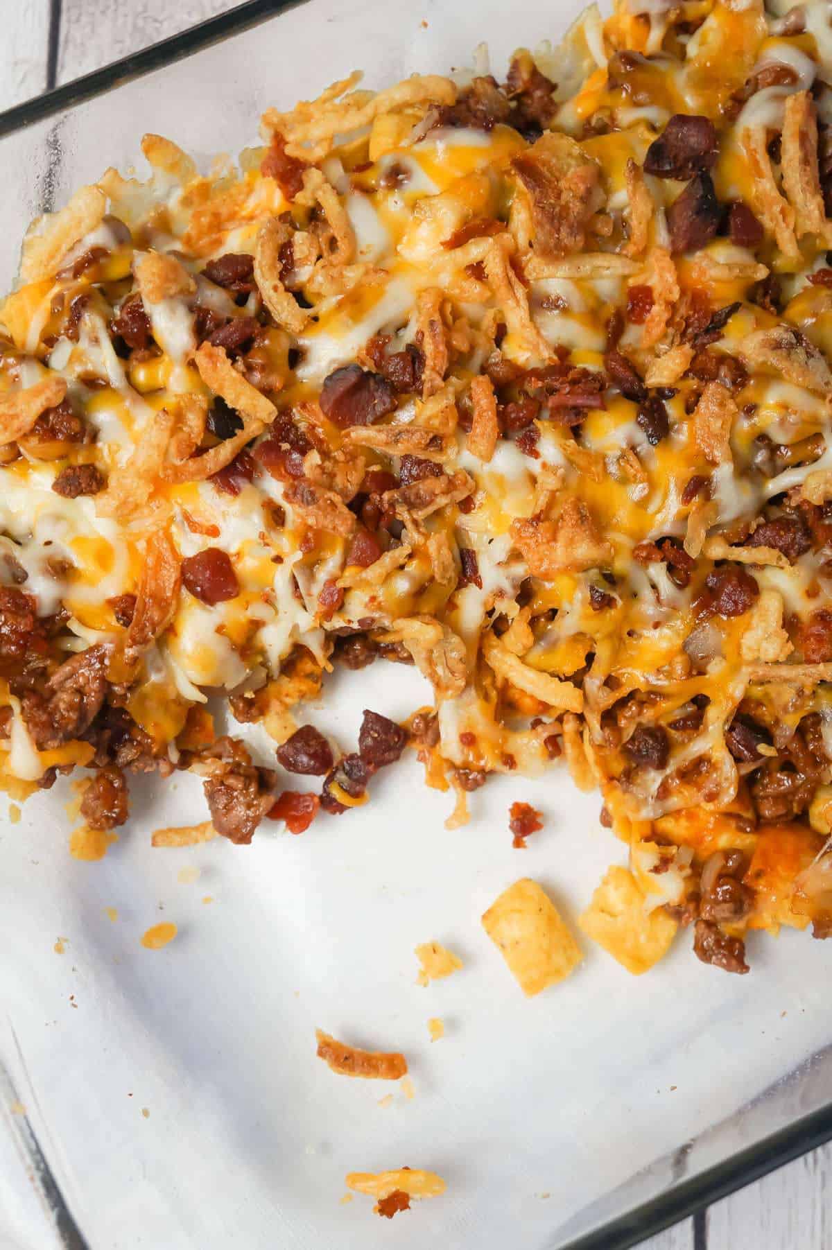 BBQ Bacon Cheeseburger Frito Pie is a delicous casserole with a base of Fritos corn chips, topped with ground beef and bacon crumble tossed in BBQ sauce, shredded cheese and French's fried onions.