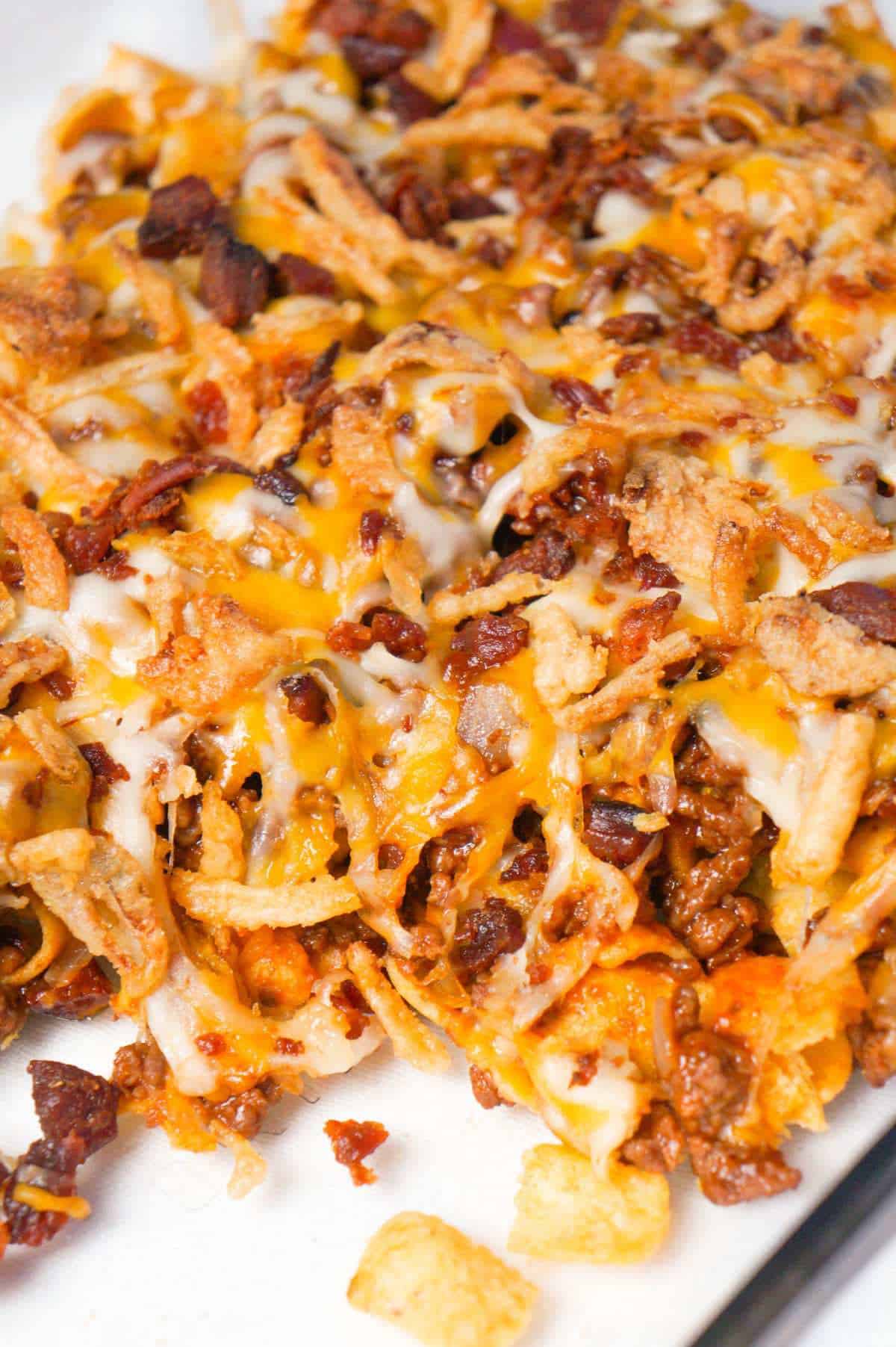 BBQ Bacon Cheeseburger Frito Pie is a delicous casserole with a base of Fritos corn chips, topped with ground beef and bacon crumble tossed in BBQ sauce, shredded cheese and French's fried onions.