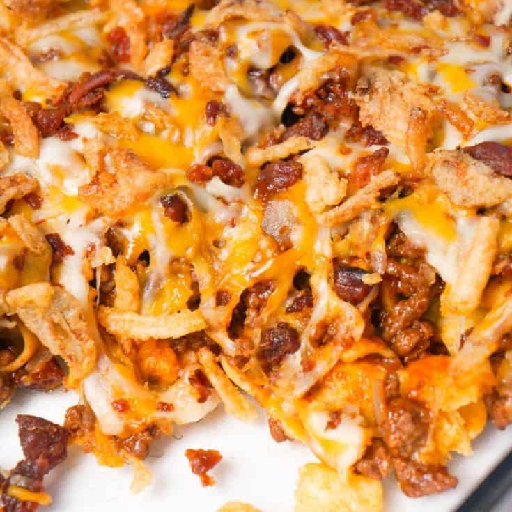 BBQ Bacon Cheeseburger Frito Pie is a delicous casserole with a base of Fritos corn chips, topped with ground beef and bacon crumble tossed in BBQ sauce, shredded cheese and French's fried onions.