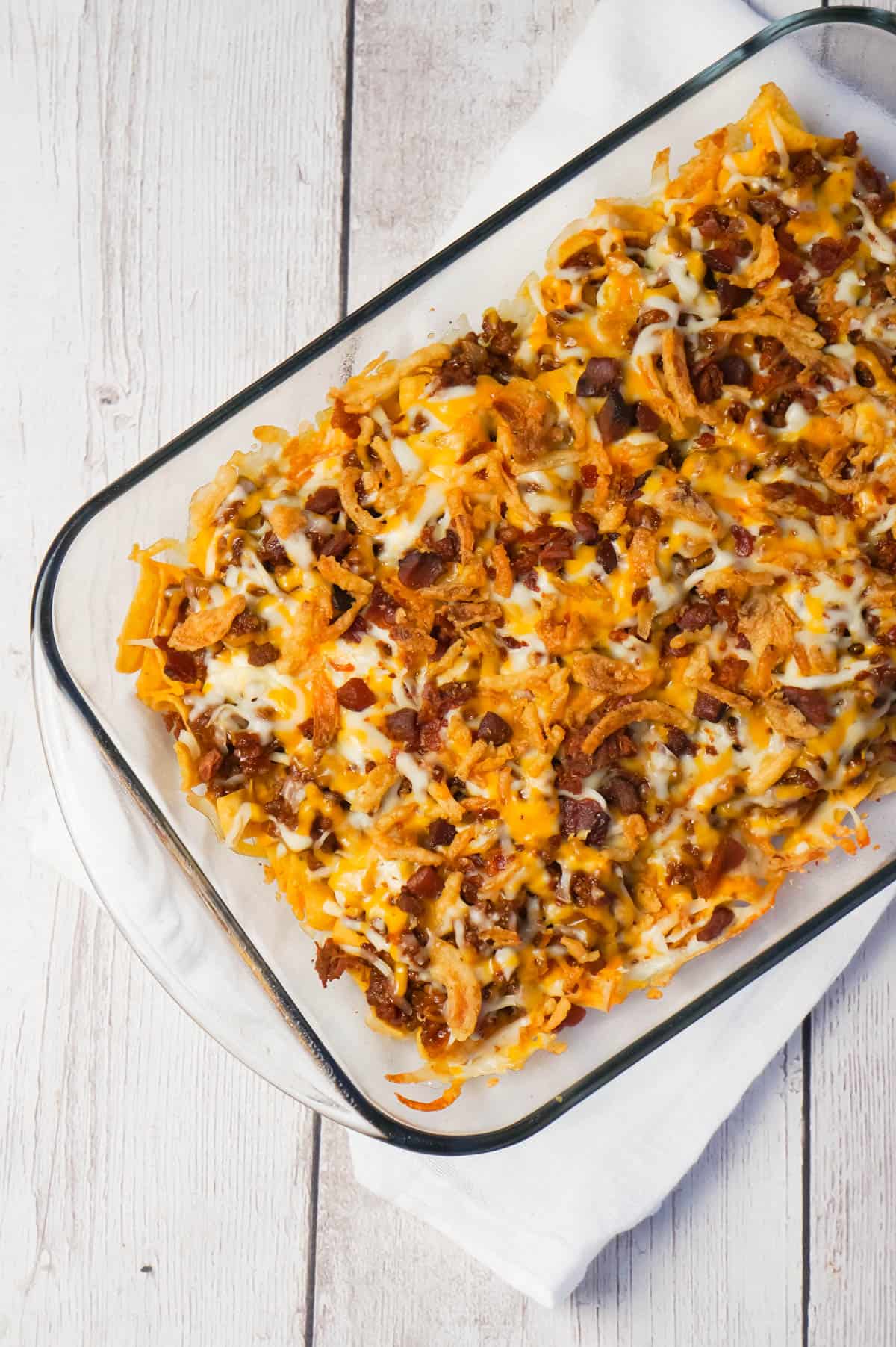 BBQ Bacon Cheeseburger Frito Pie is a delicous casserole with a base of Fritos corn chips, topped with ground beef and bacon crumble tossed in BBQ sauce, shredded cheese and French's fried onions.