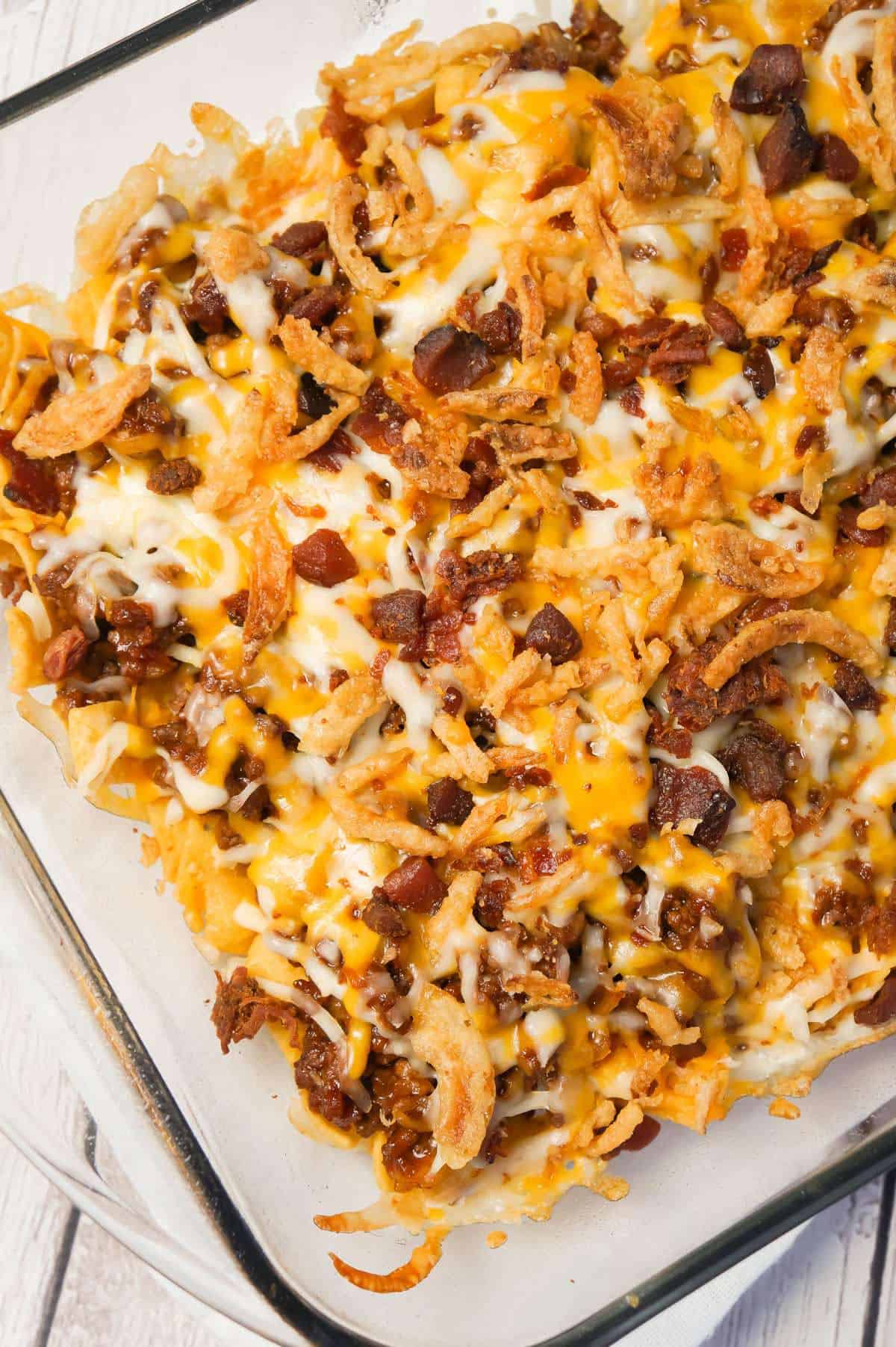 BBQ Bacon Cheeseburger Frito Pie is a delicous casserole with a base of Fritos corn chips, topped with ground beef and bacon crumble tossed in BBQ sauce, shredded cheese and French's fried onions.