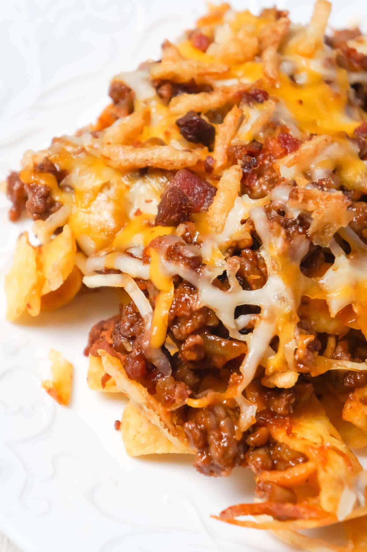 BBQ Bacon Cheeseburger Frito Pie is a delicous casserole with a base of Fritos corn chips, topped with ground beef and bacon crumble tossed in BBQ sauce, shredded cheese and French's fried onions.