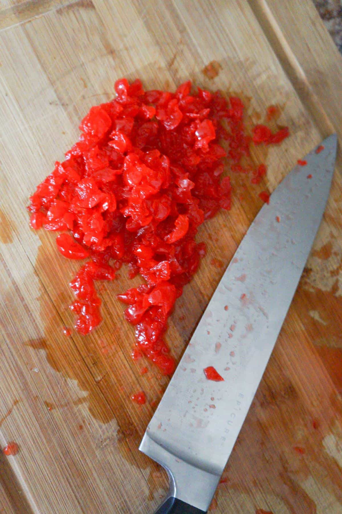 chopped maraschino cherries on a cutting board
