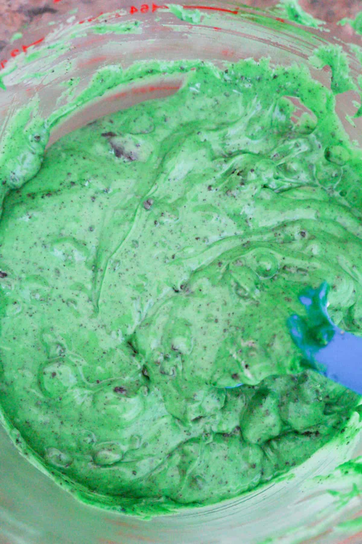 green cookie and cream fudge mixture in a mixing bowl