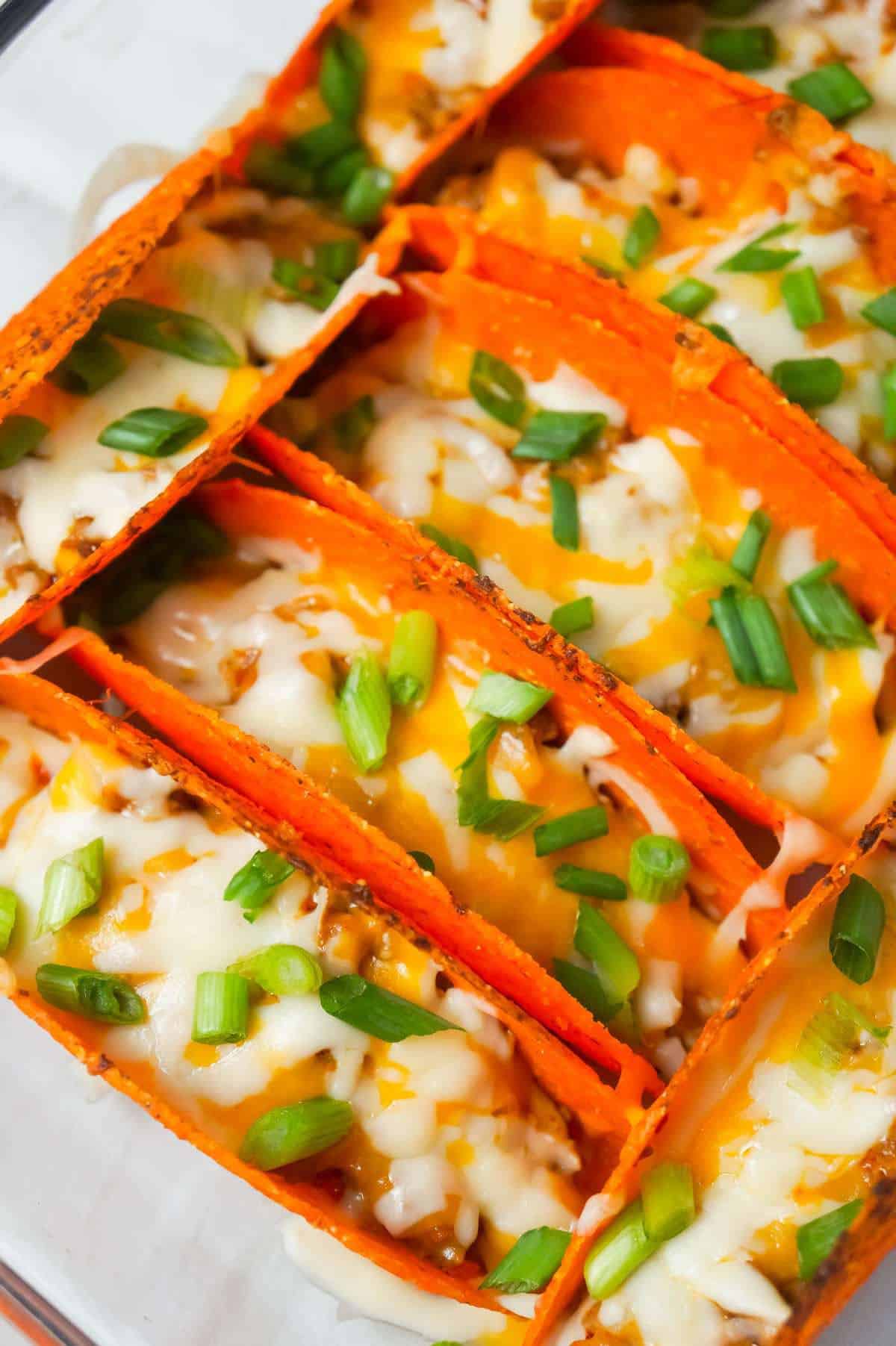 Extra Cheesy Baked Beef Tacos are an easy weeknight dinner recipe using ground beef, salsa con queso cheese dip, shredded mozzarella and cheddar and nacho cheese flavoured stand and stuff taco shells.