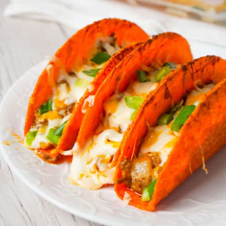 Extra Cheesy Baked Beef Tacos are an easy weeknight dinner recipe using ground beef, salsa con queso cheese dip, shredded mozzarella and cheddar and nacho cheese flavoured stand and stuff taco shells.