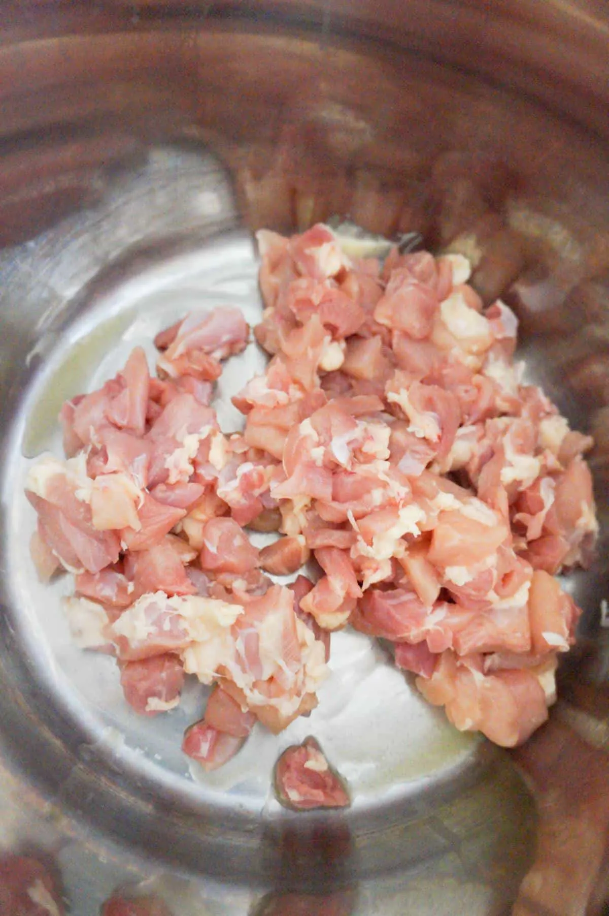 raw chicken chunks in an Instant Pot