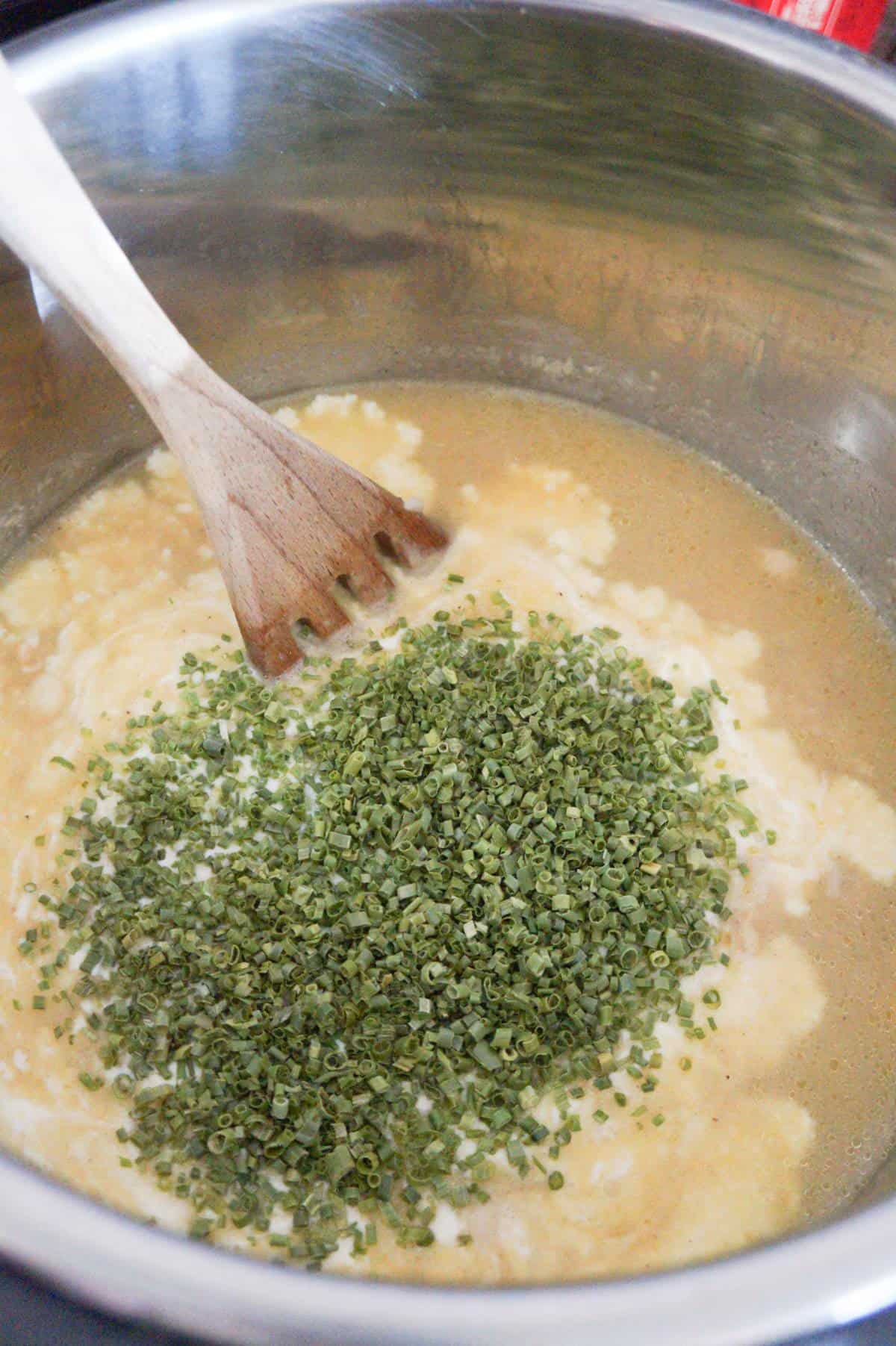 chopped chives on top of cream of chicken soup in an Instant Pot