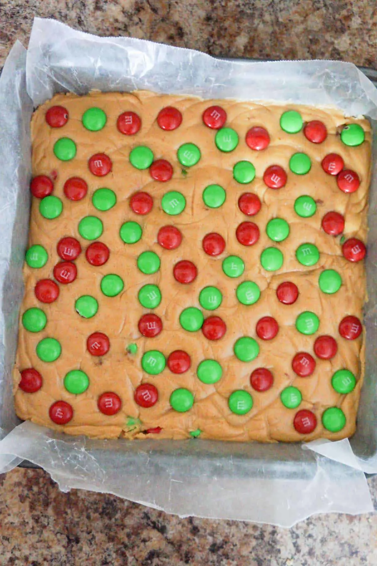 red and green M&M's on top of peanut butter fudge