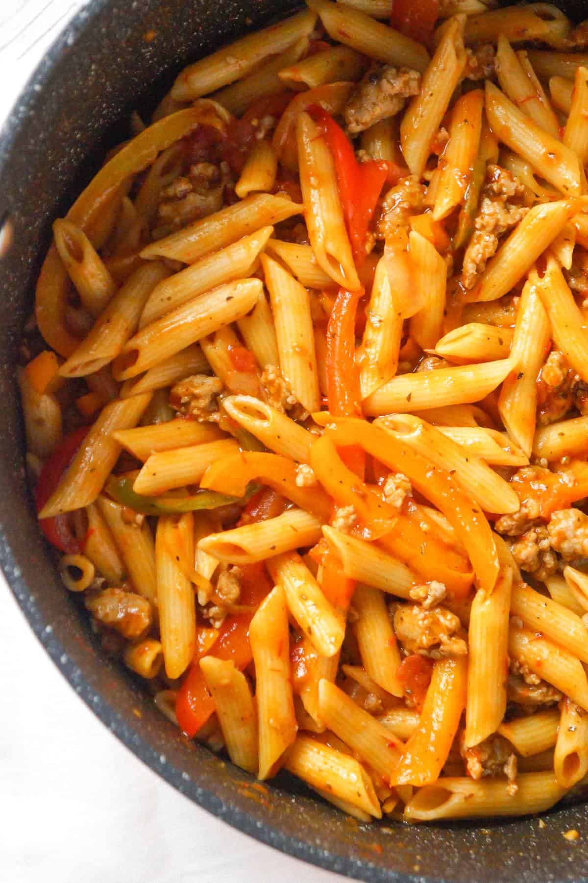 Sausage and Peppers Pasta is a delicious dinner recipe using penne pasta and loaded with sliced bell peppers, onions and Italian sausage meat.