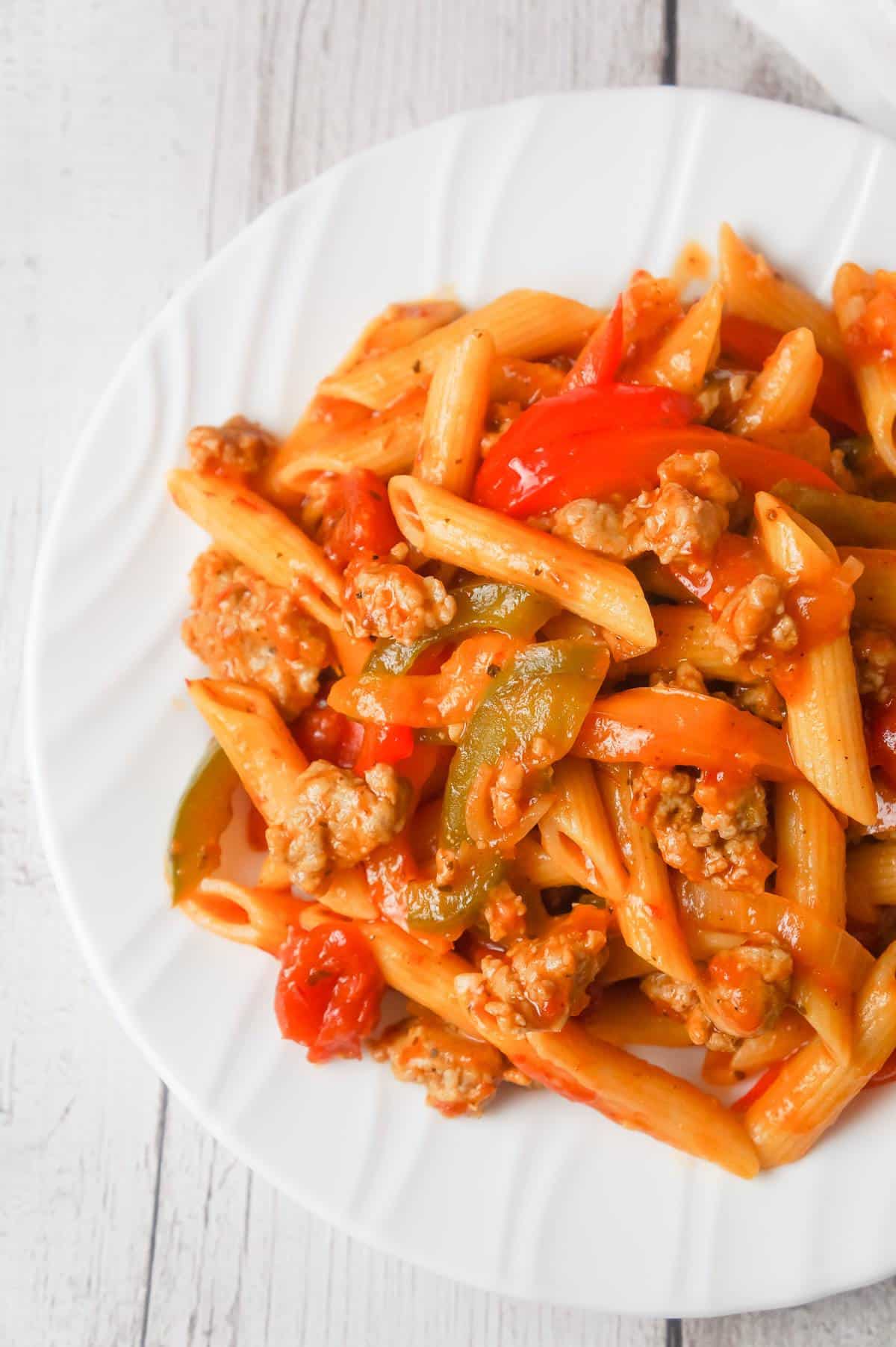 Sausage and Peppers Pasta is a delicious dinner recipe using penne pasta and loaded with sliced bell peppers, onions and Italian sausage meat.