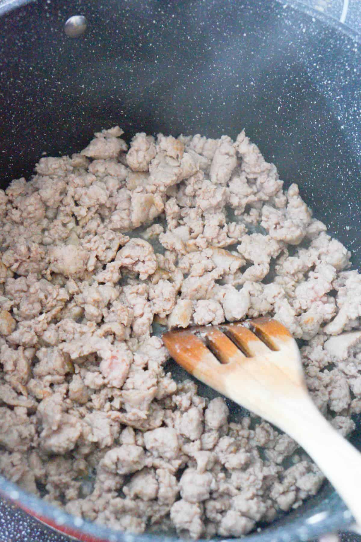 cooked and crumbled sausage meat in a large pot