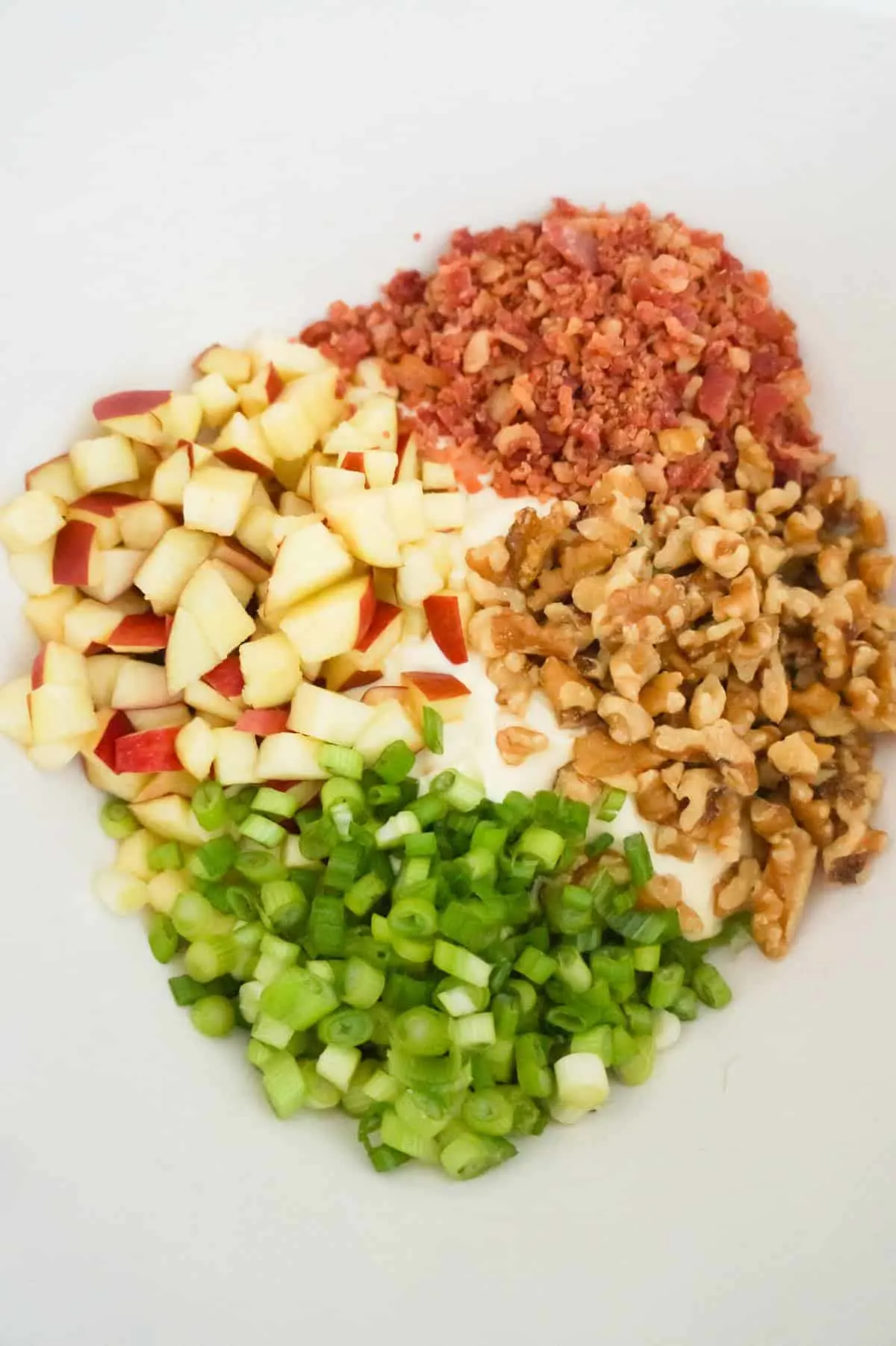 diced apples, chopped green onions, chopped walnuts and crumbled bacon in a mixing bowl