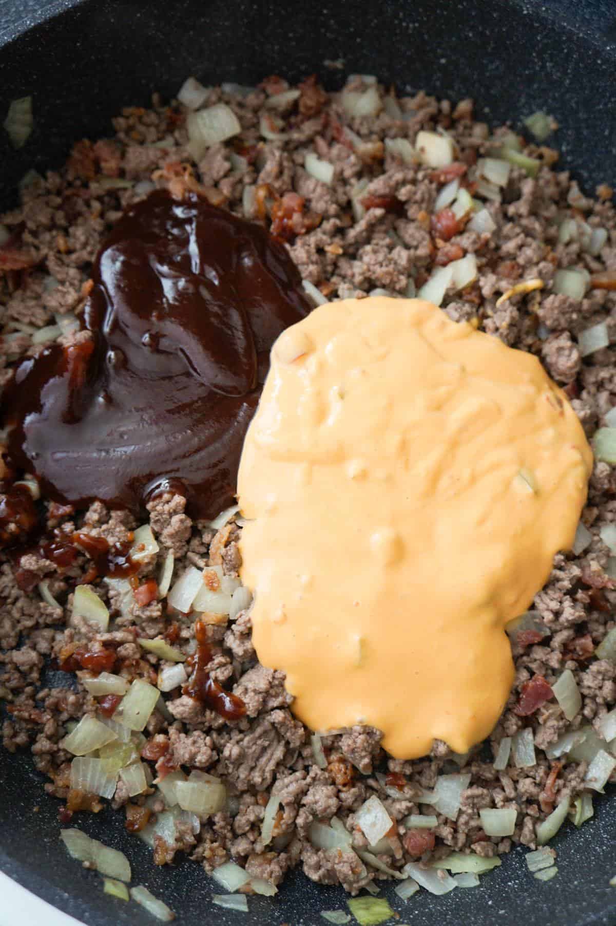 bbq sauce and salsa con queso on top of cooked ground beef