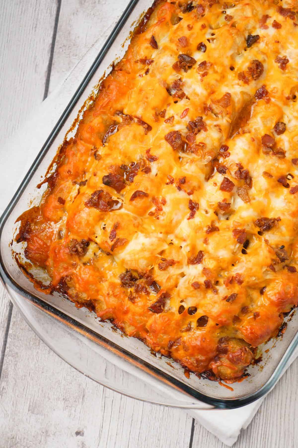 Cheesy Tater Tot Meatloaf Casserole is an easy ground beef dinner recipe with a meatloaf base, topped with a ketchup and bbq sauce glaze, tater tots, shredded cheese and crumbled bacon.