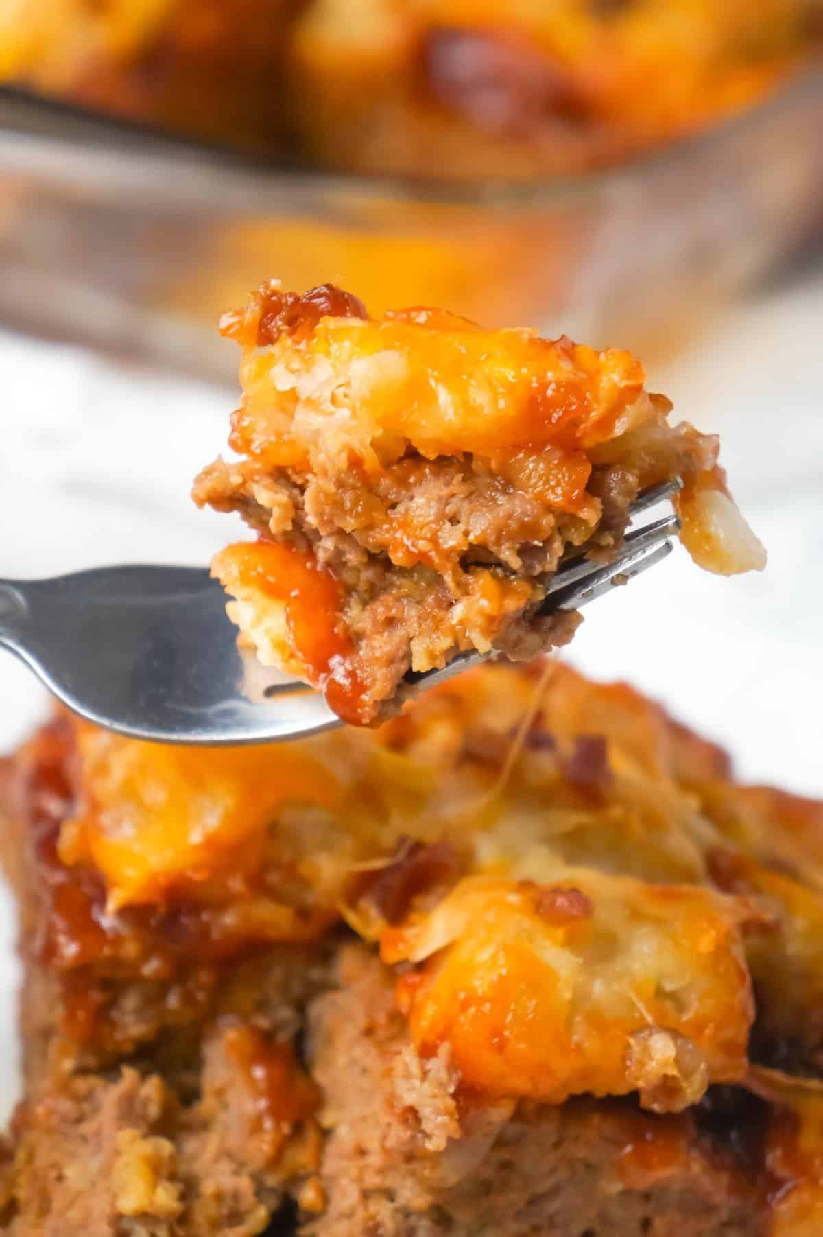 Cheesy Tater Tot Meatloaf Casserole is an easy ground beef dinner recipe with a meatloaf base, topped with a ketchup and bbq sauce glaze, tater tots, shredded cheese and crumbled bacon.