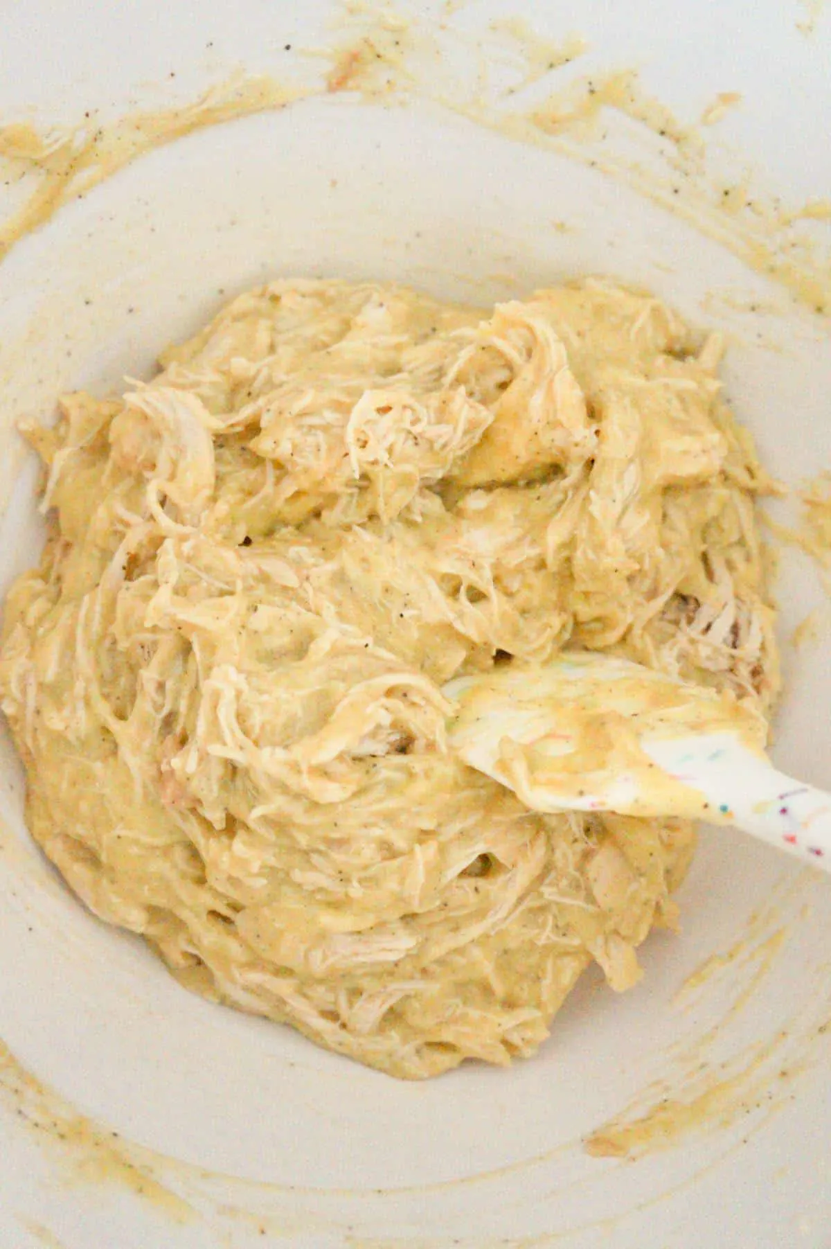 shredded chicken and cream of chicken soup mixture in a mixing bowl