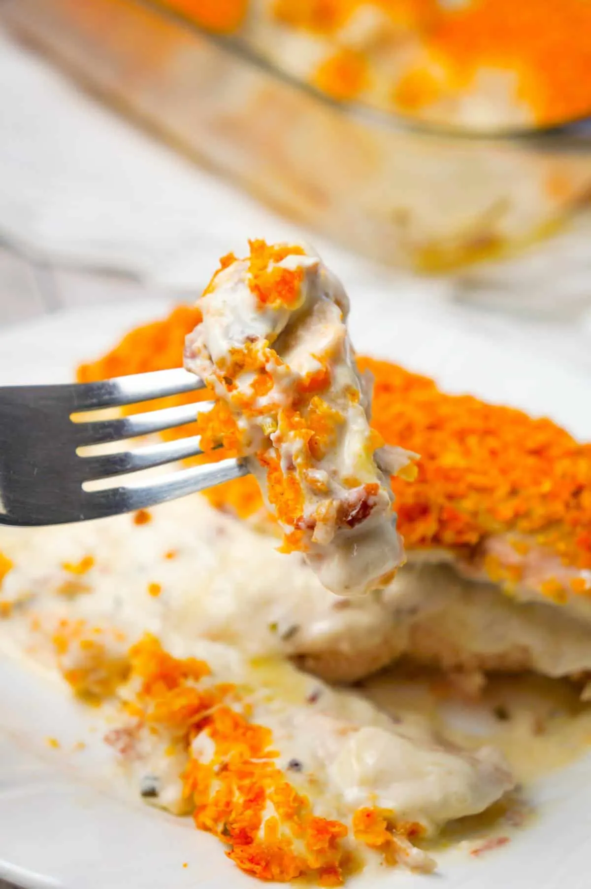 Cream Cheese and Bacon Stuffed Doritos Chicken is a delcious stuffed chicken breast recipe made with chive and onion cream cheese, cream of bacon soup, cumbled bacon and crushed Doritos.