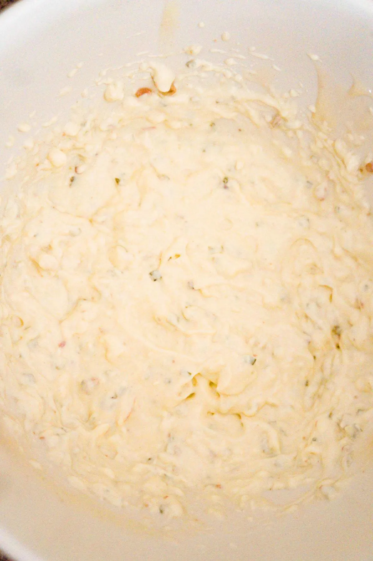 cream cheese and cream of bacon soup mixture in a mixing bowl