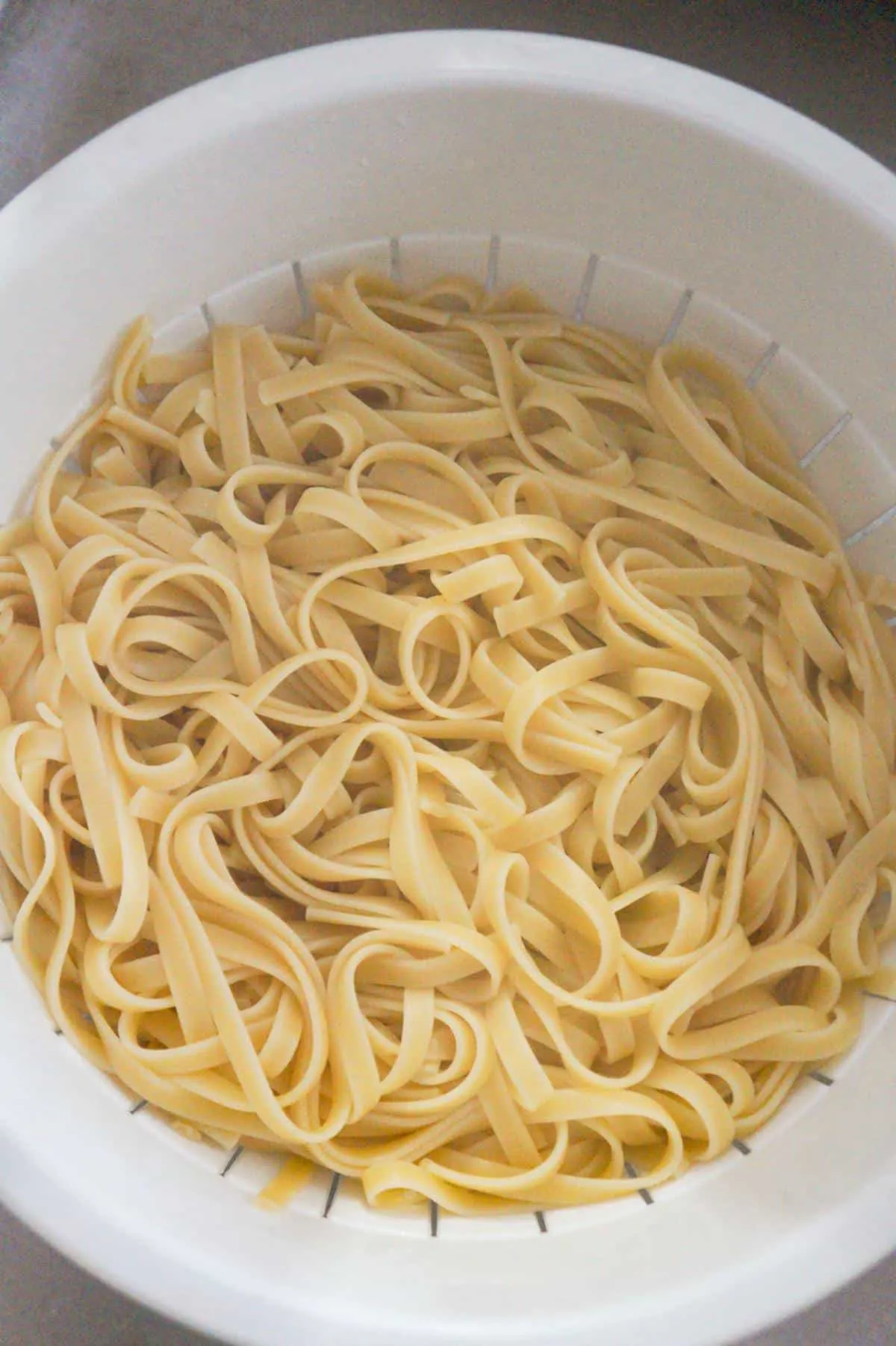 cooked fettuccine in a strainer