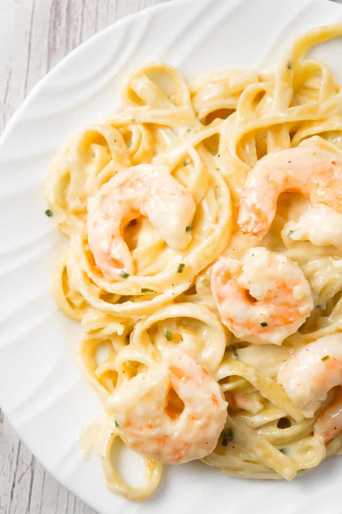 Fettuccine Alfredo with Shrimp is a delicious seafood pasta recipe with a creamy garlic parmesan sauce.