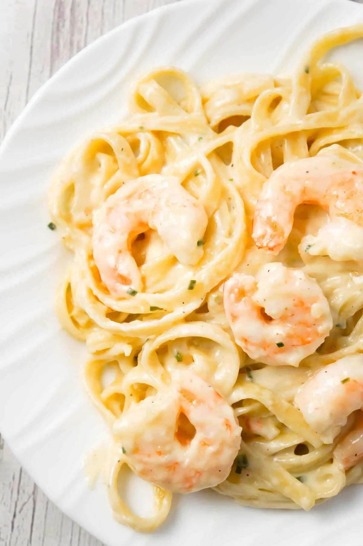 Fettuccine Alfredo with Shrimp is a delicious seafood pasta recipe with a creamy garlic parmesan sauce.