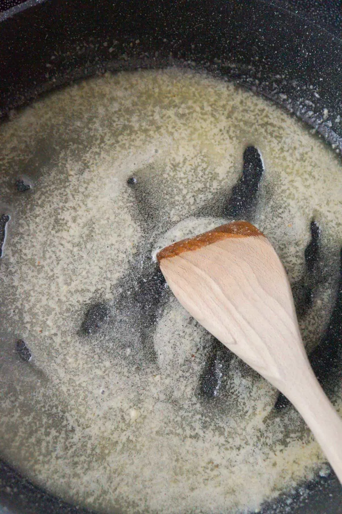 garlic puree and melted butter in a large pan