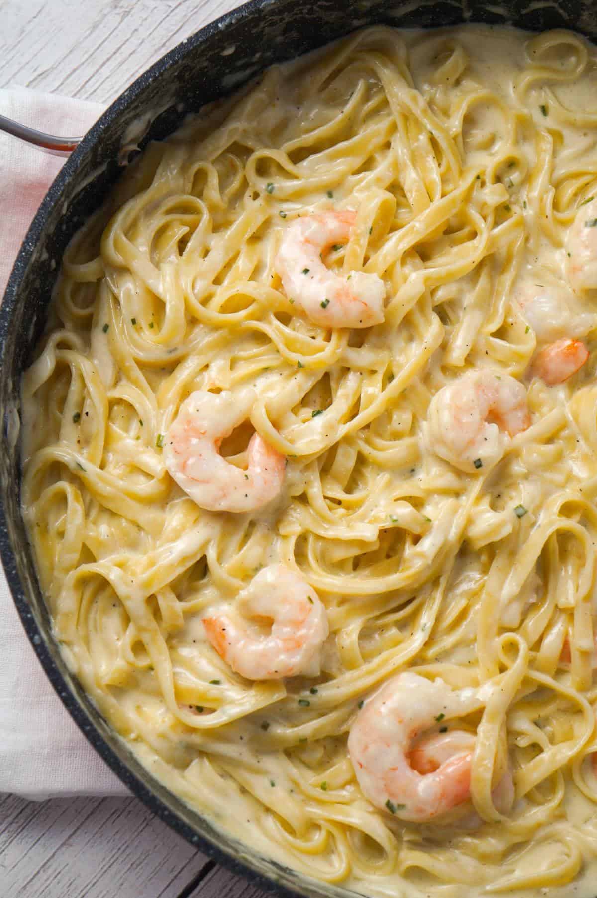Fettuccine Alfredo with Shrimp is a delicious seafood pasta recipe with a creamy garlic parmesan sauce.