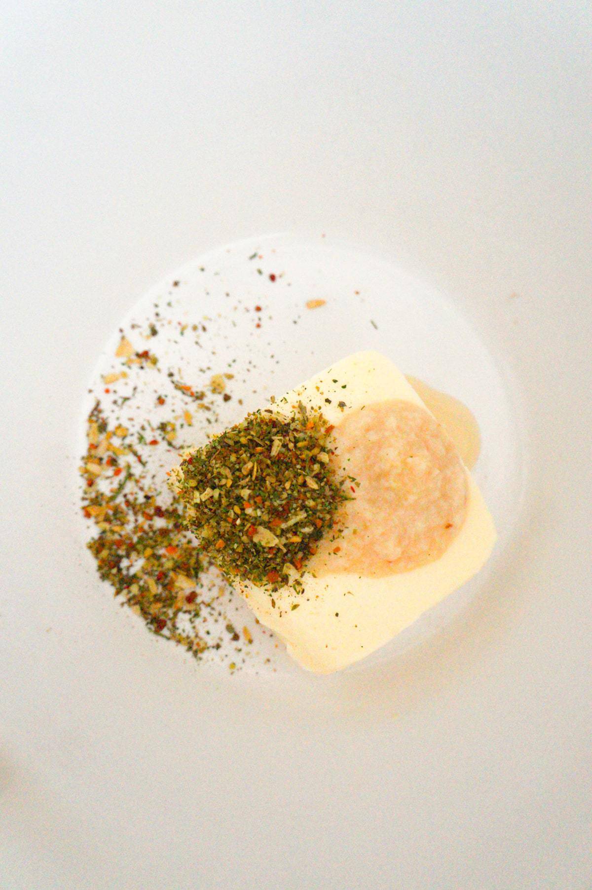 softened butter, Italian seasoning and garlic puree in a mixing bowl