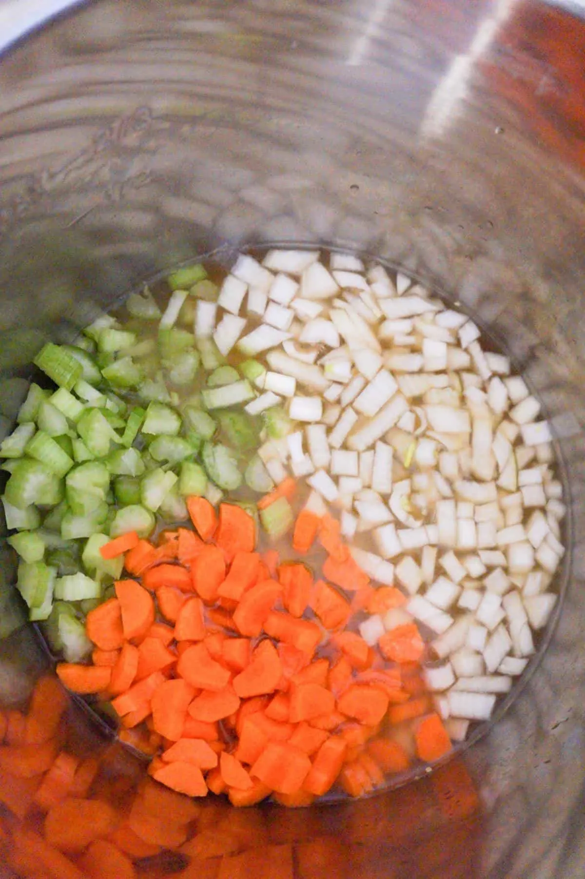chopped celery, onions and carrots in an Instant Pot