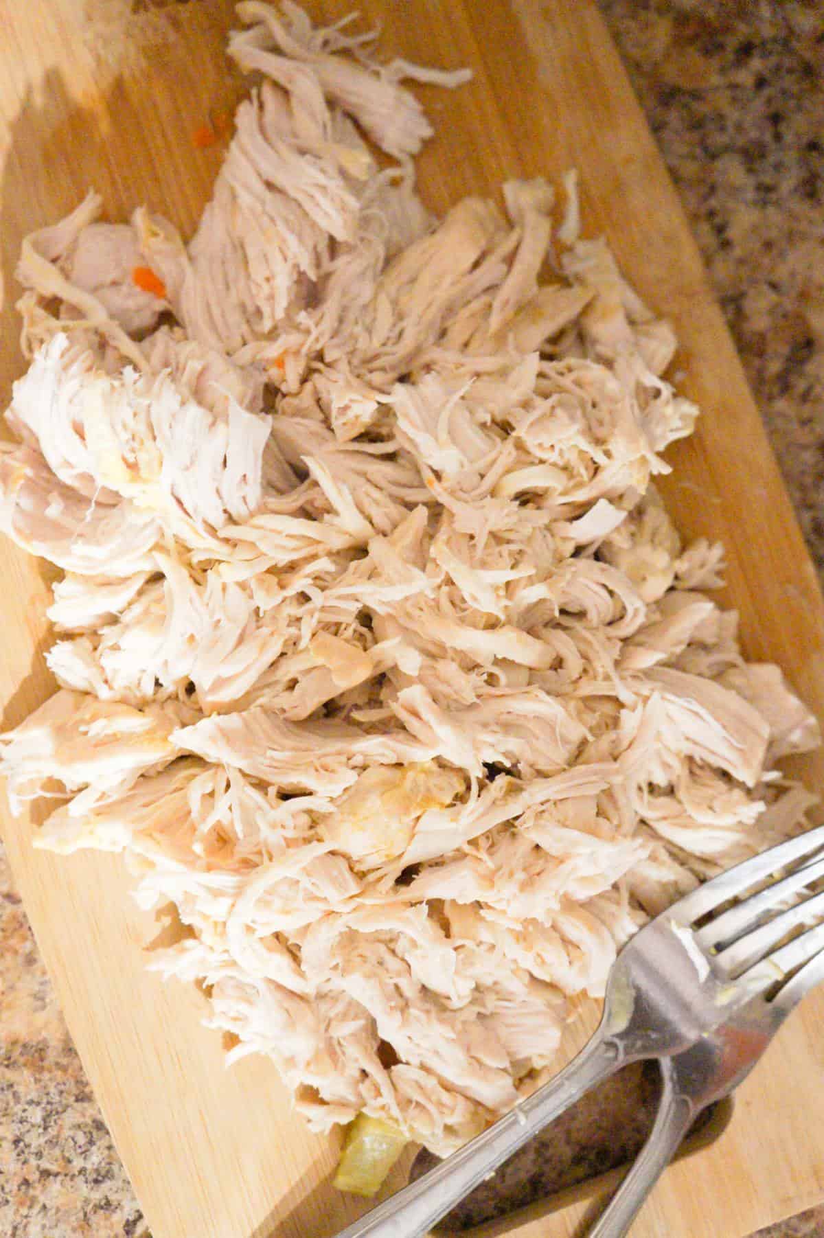 shredded chicken on a cutting board