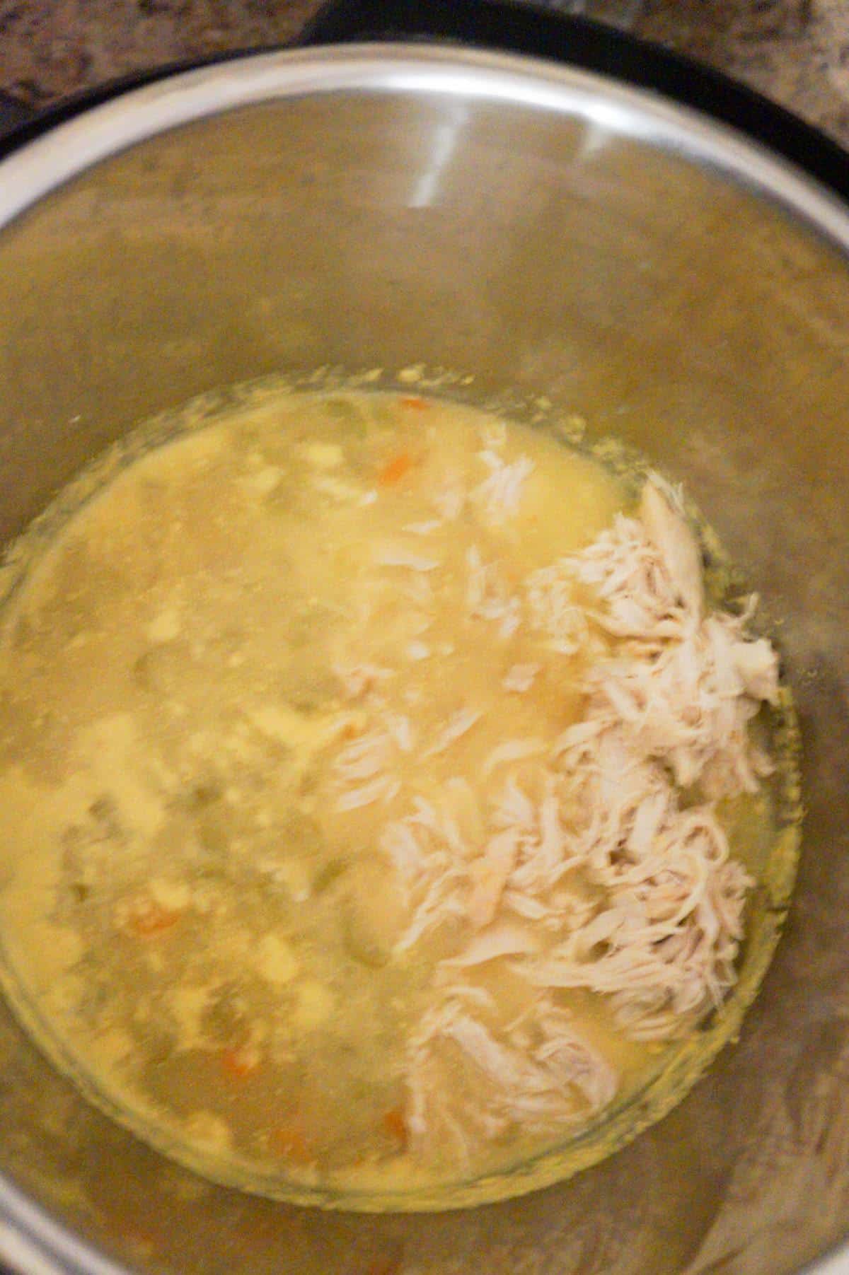 shredded chicken in chicken broth in an Instant Pot