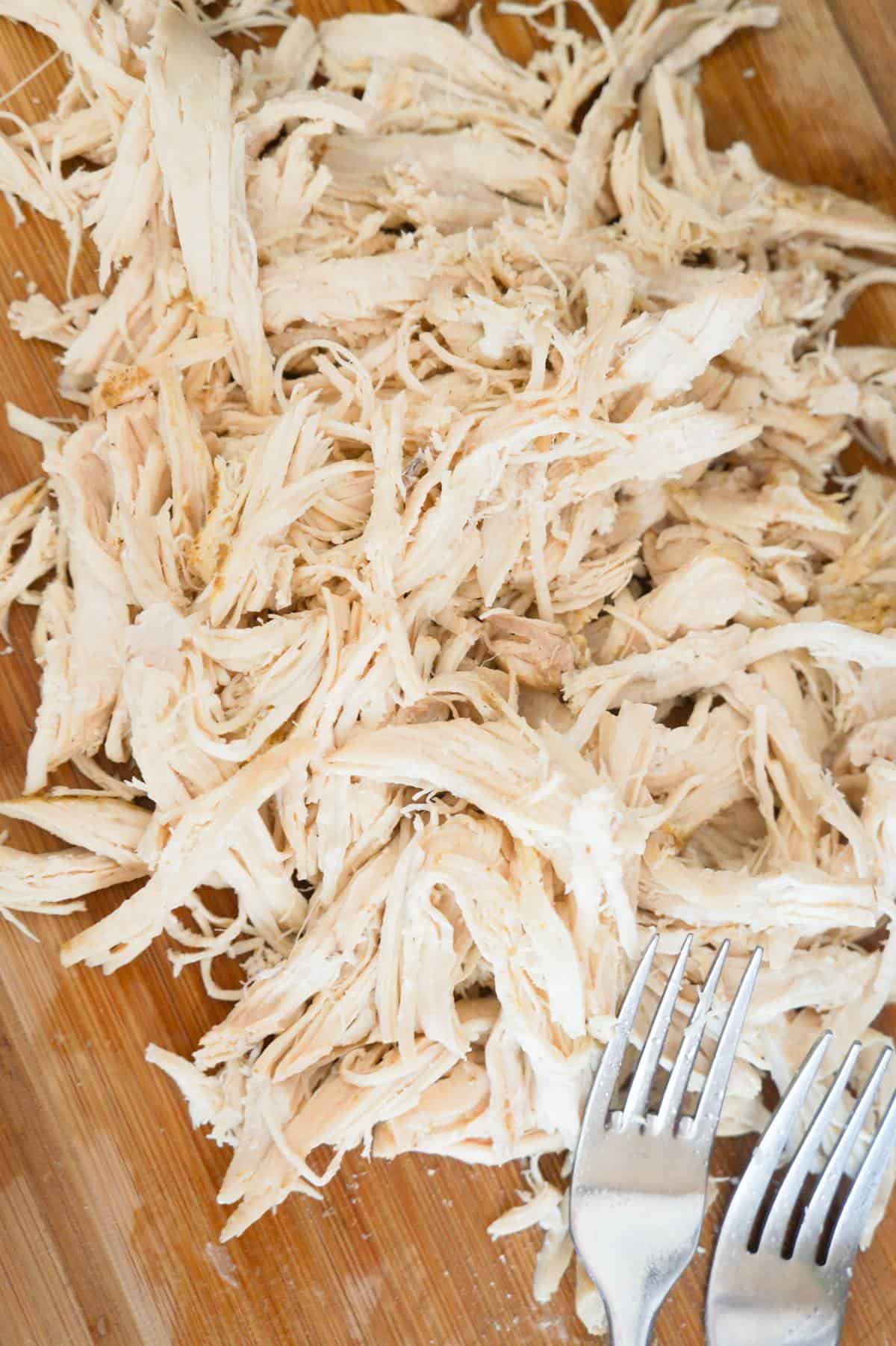 shredded chicken on a cutting board