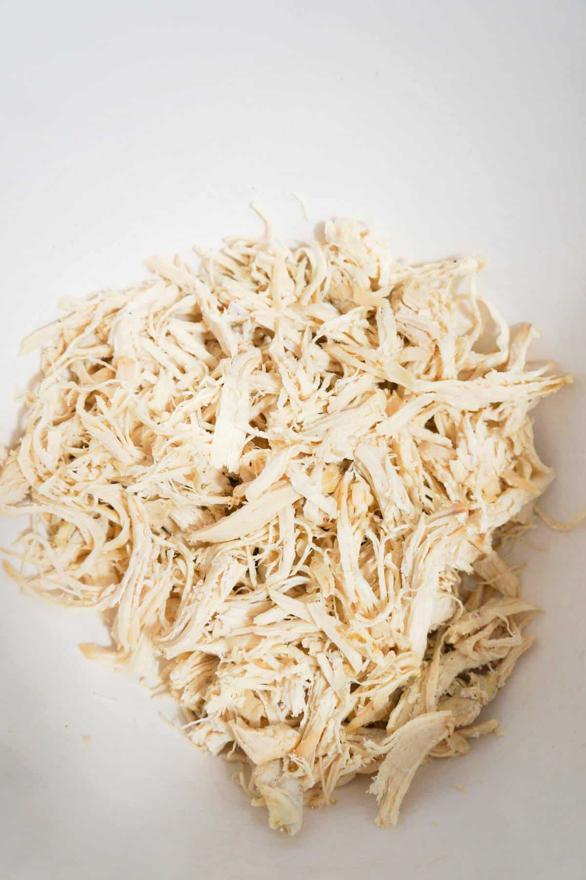 shredded chicken in a mixing bowl