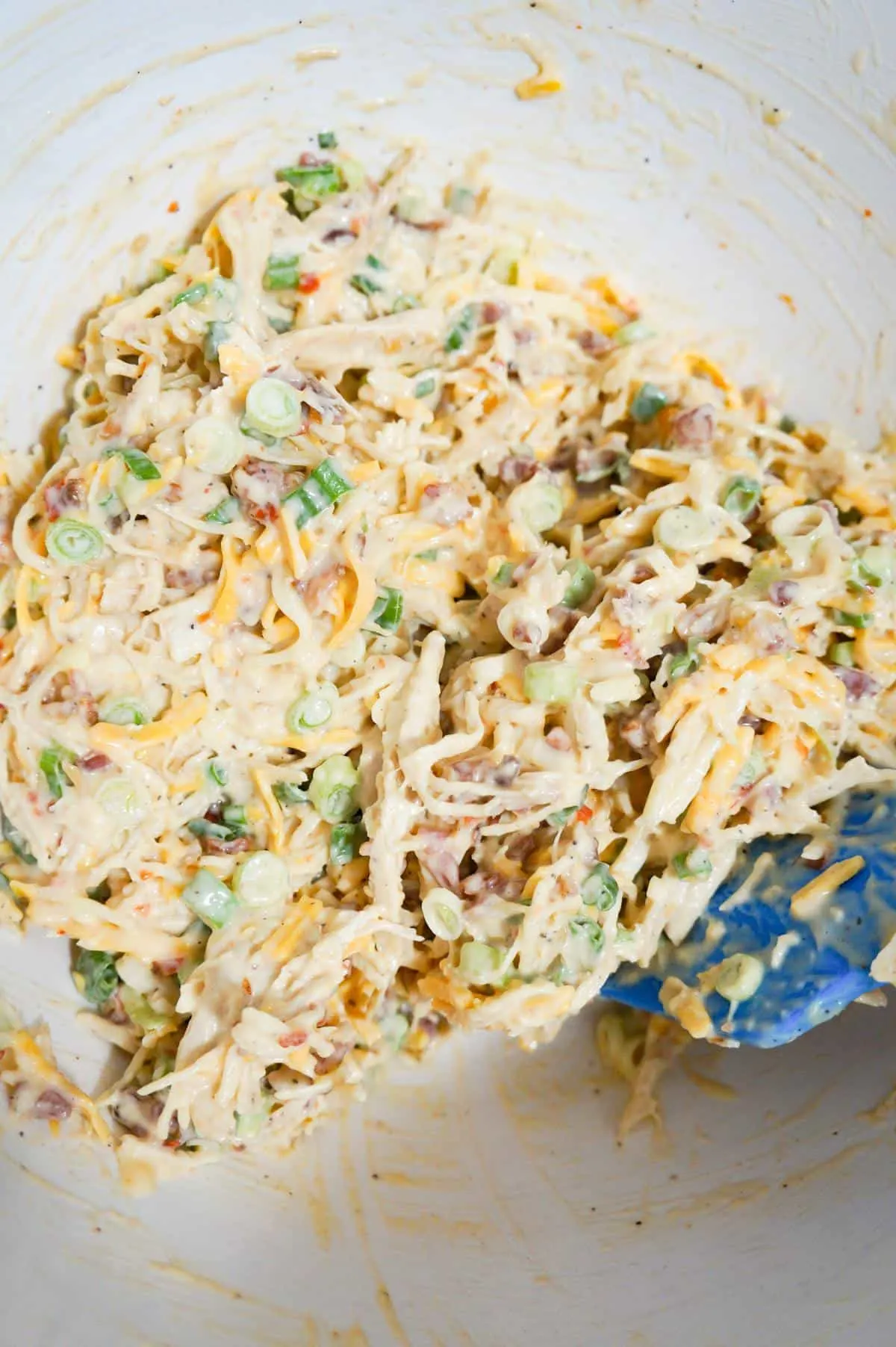 sweet chili bacon chicken salad in a mixing bowl