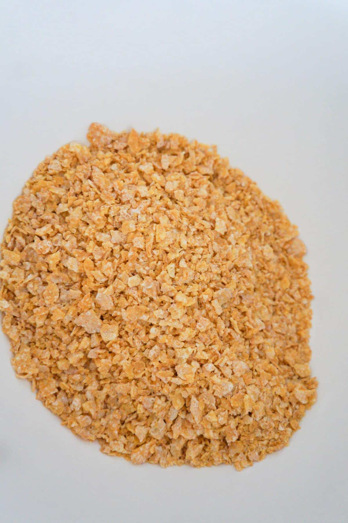 Frosted Flakes crumbs in a mixing bowl