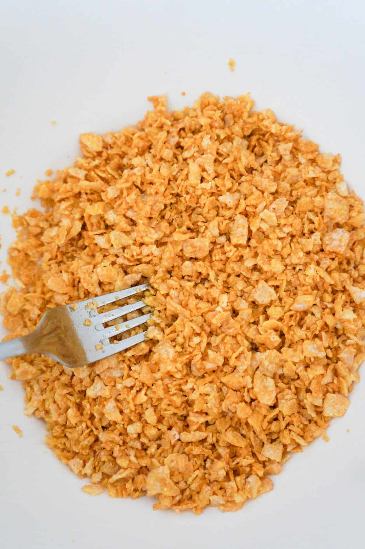 crushed Frosted Flakes in a mixing bowl