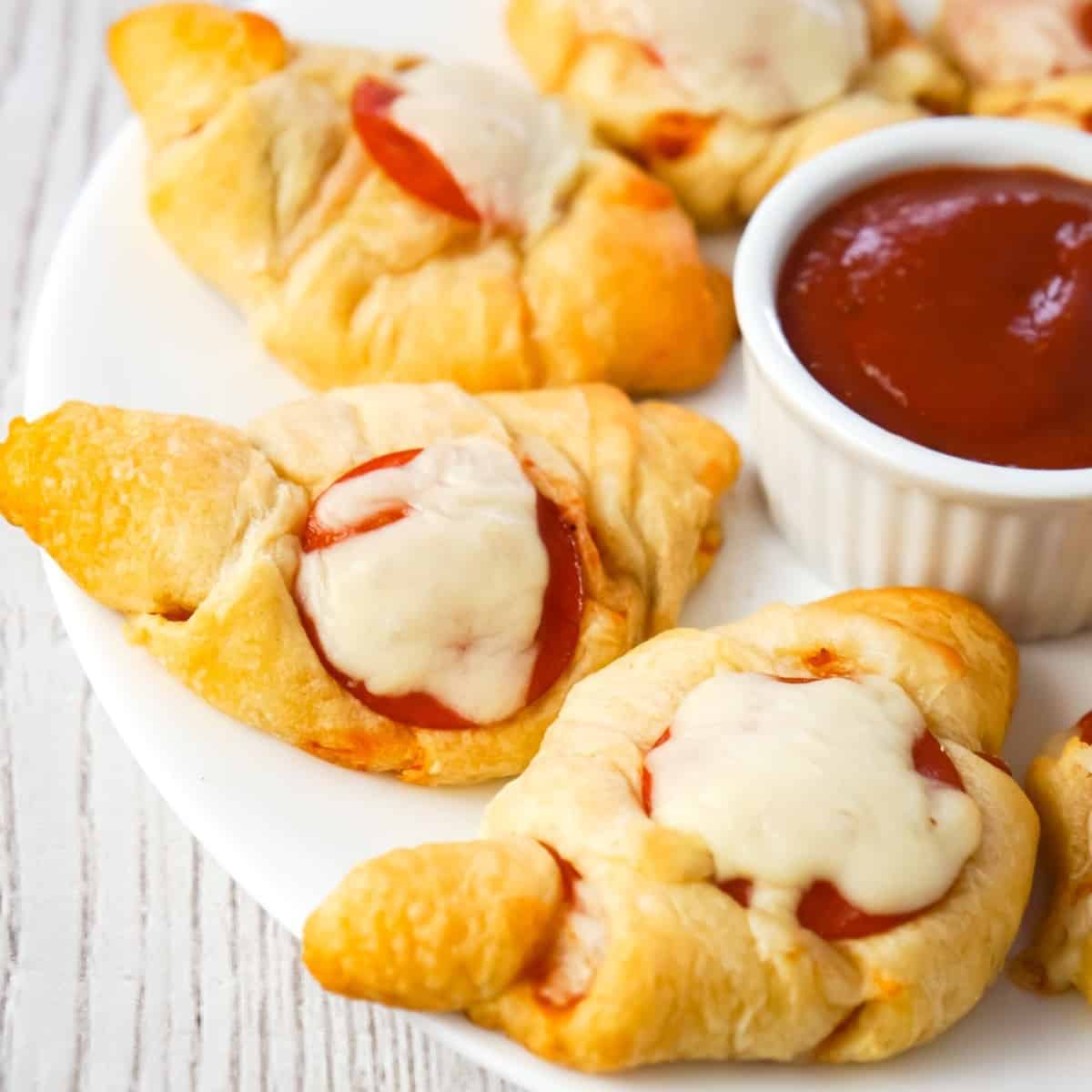 Pizza Crescent Rolls are an easy dinner or party snack recipe using Pillsbury crescent rolls, pepperoni, mozzarella cheese and pizza sauce.